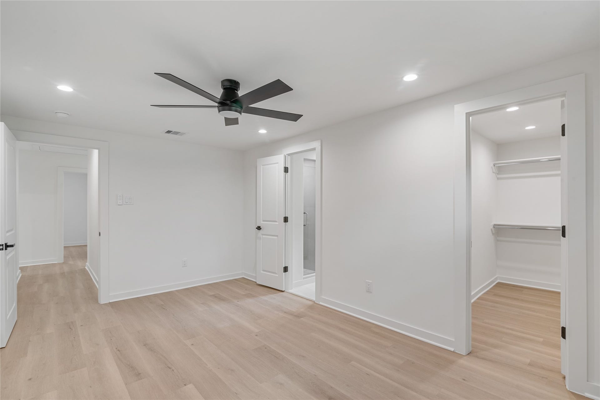 703 Newton Drive, Richmond, TX 77469 Additional bedroom view highlighting the generous floor space, ceiling fan, and access to adjoining rooms.