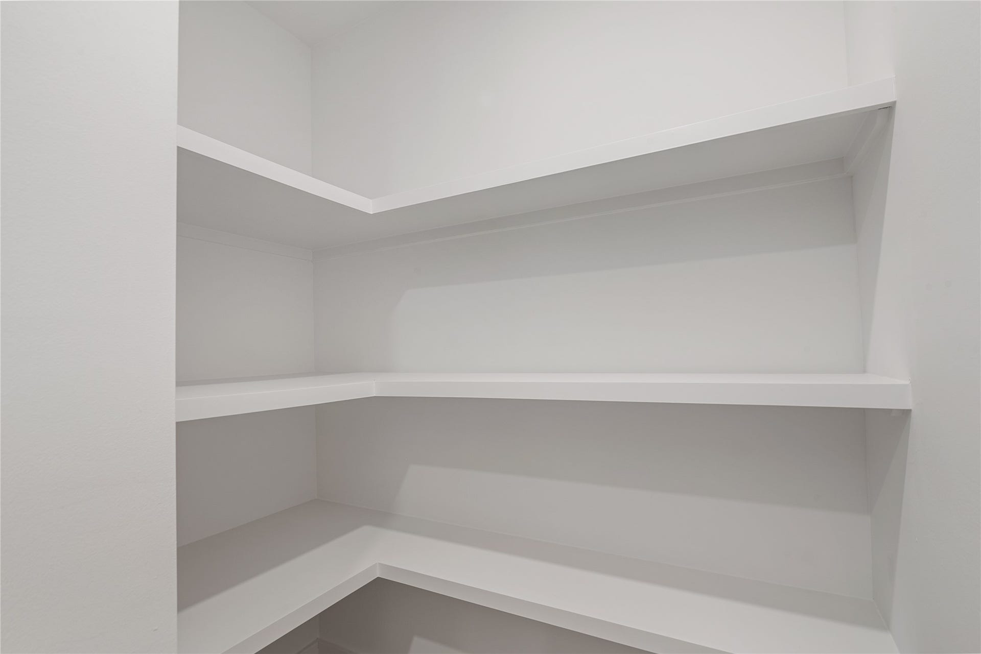 703 Newton Drive, Richmond, TX 77469 Built-in pantry shelving provides convenient storage and organization just off the kitchen.