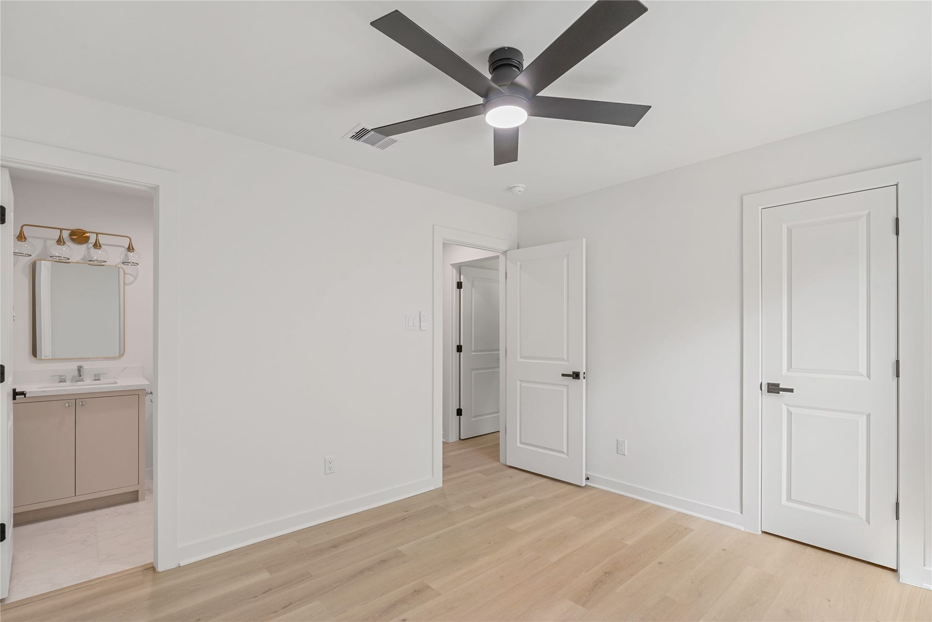 703 Newton Drive, Richmond, TX 77469 Another view of the bedroom showcasing the double-door closet, contemporary ceiling fan, and fresh neutral finishes.