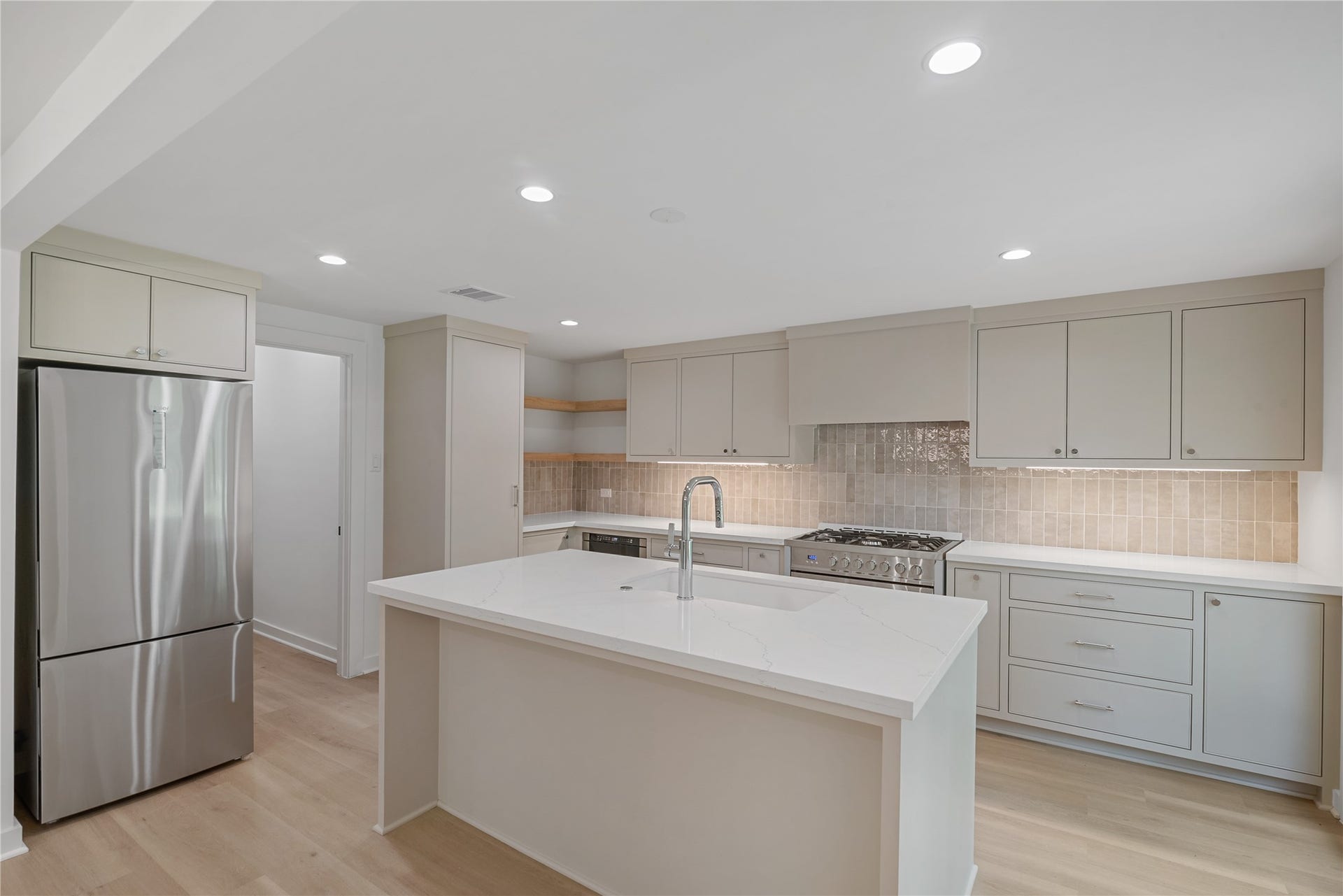 703 Newton Drive, Richmond, TX 77469 Spacious kitchen offers generous counter space, an oversized island, modern cabinetry, and a bright, open layout.
