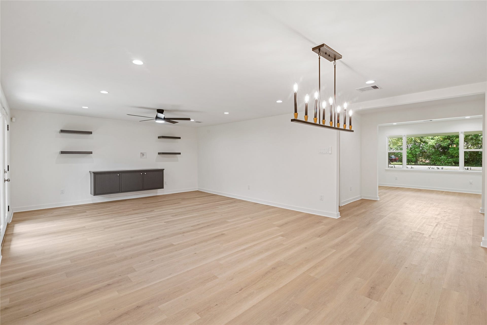 703 Newton Drive, Richmond, TX 77469 Spacious open-concept layout with contemporary lighting, abundant natural light, and flexible space for dining and entertaining.