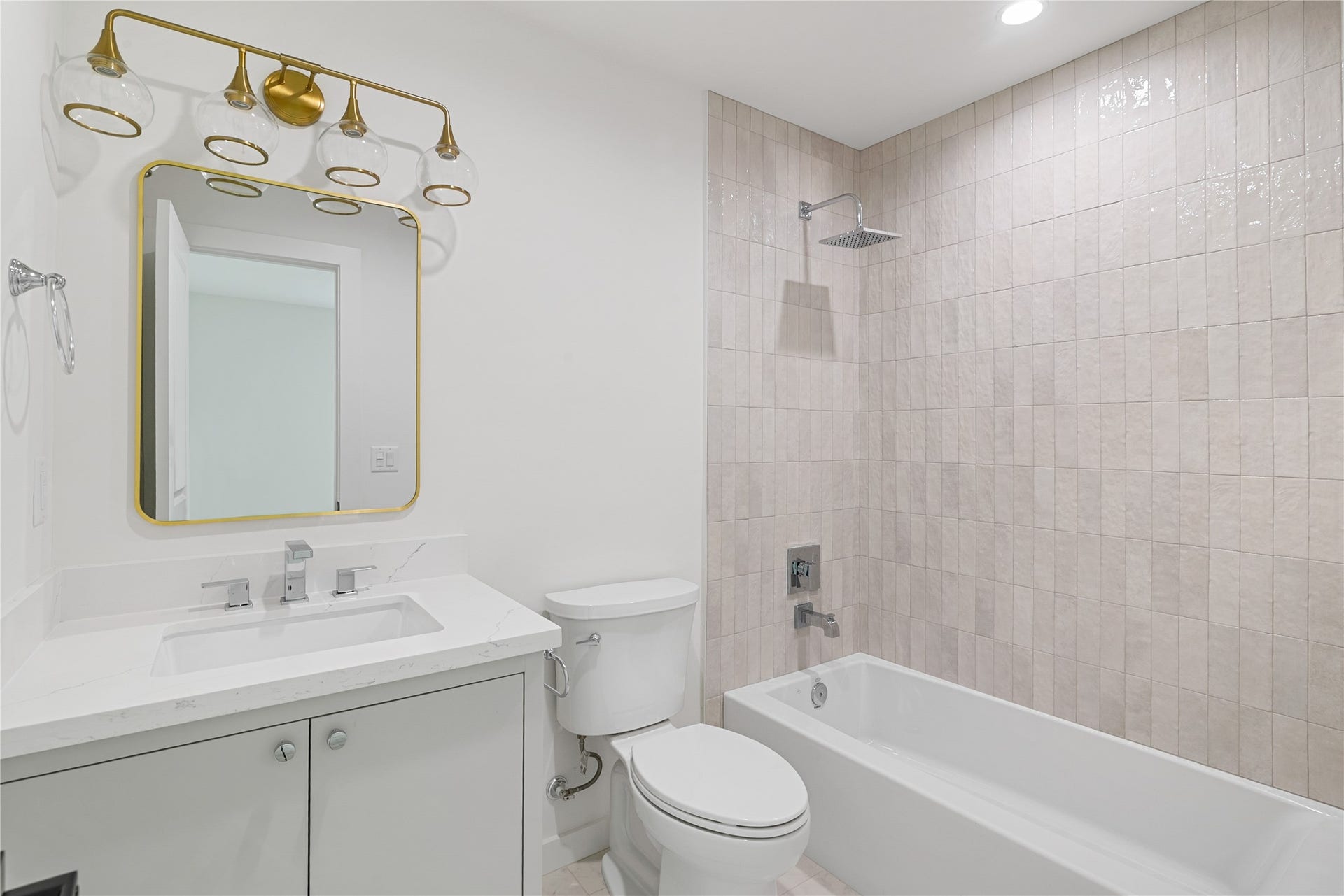 703 Newton Drive, Richmond, TX 77469 Updated full bathroom featuring a tub and shower combination with decorative tile surround, modern vanity, and coordinated fixtures.