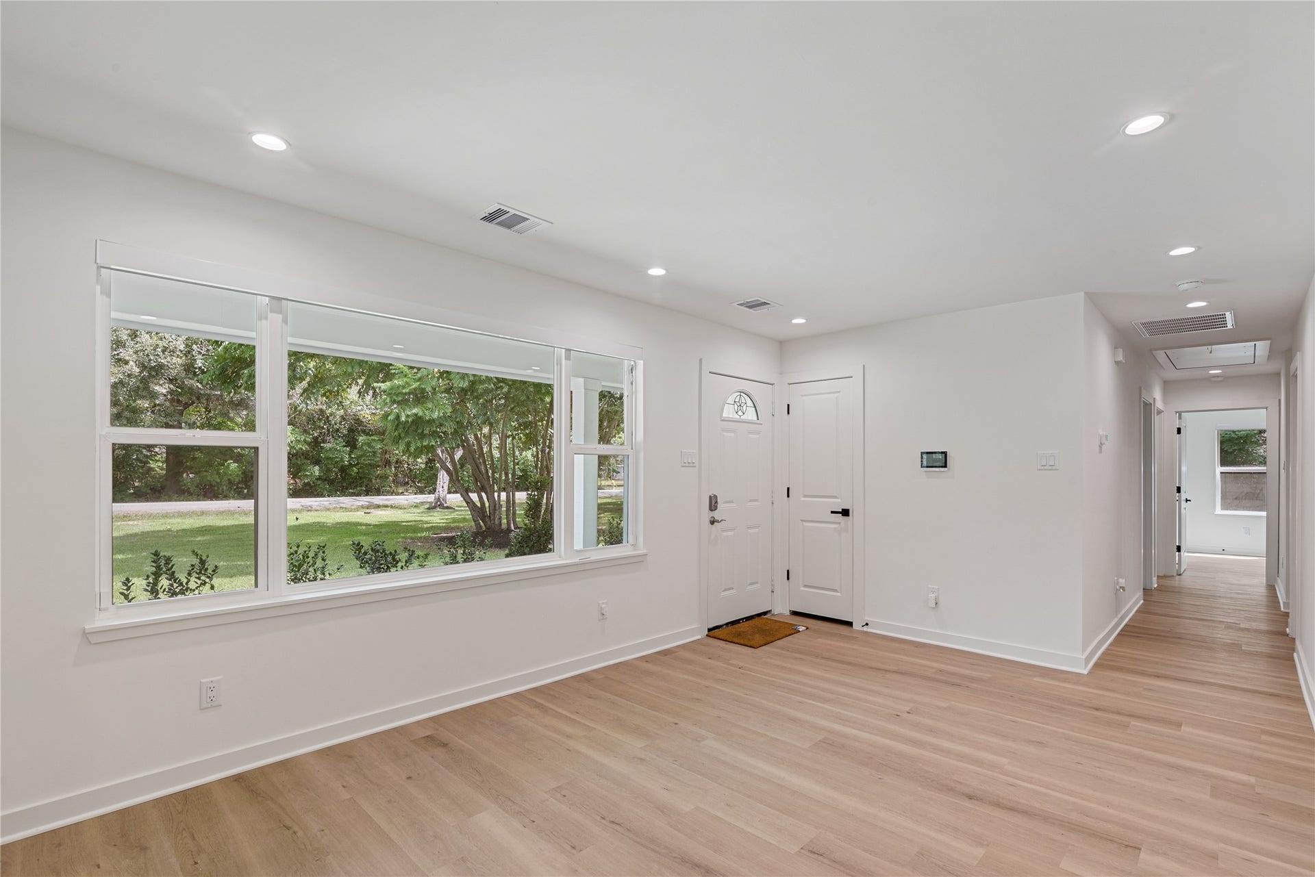 703 Newton Drive, Richmond, TX 77469 Large windows bring natural light into this versatile living space, complemented by updated flooring and fresh neutral finishes.