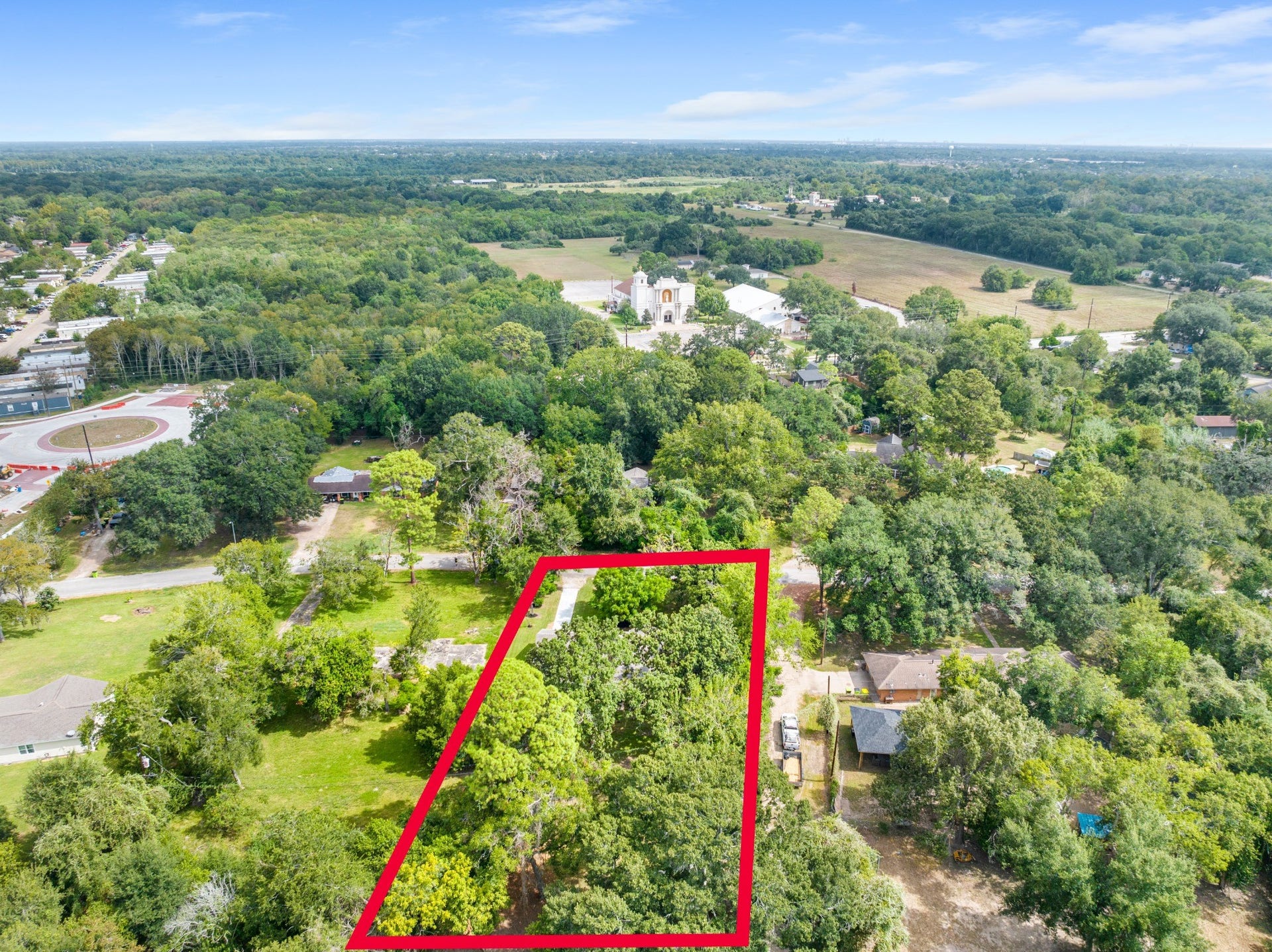 703 Newton Drive, Richmond, TX 77469 Elevated aerial perspective with approximate property boundaries marked in red, showcasing the property's generous lot dimensions.