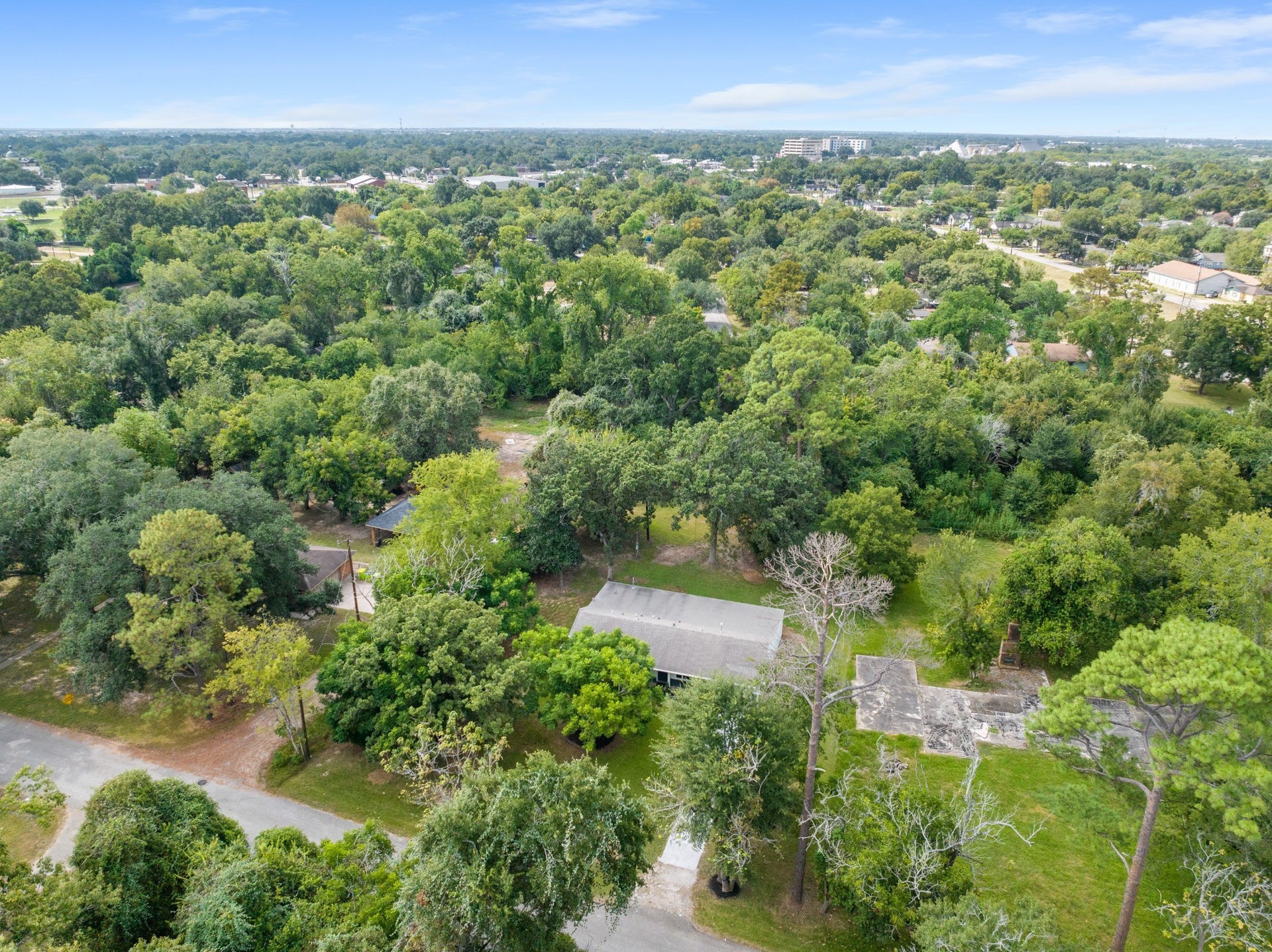 703 Newton Drive, Richmond, TX 77469 Elevated aerial perspective showcasing the home's established, tree-filled Richmond surroundings.