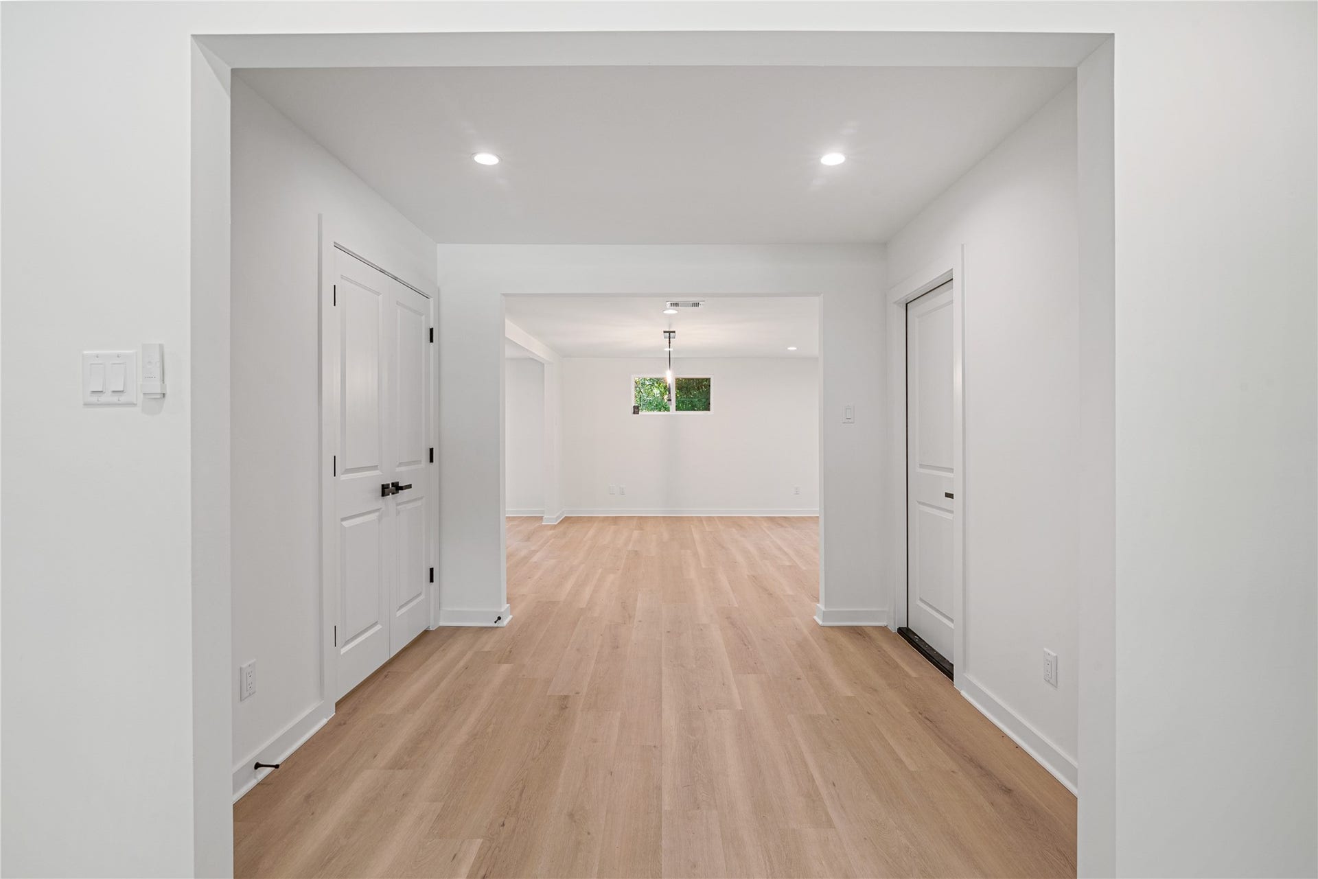 703 Newton Drive, Richmond, TX 77469 Freshly updated hallway with neutral finishes, recessed lighting, and access to adjoining rooms.