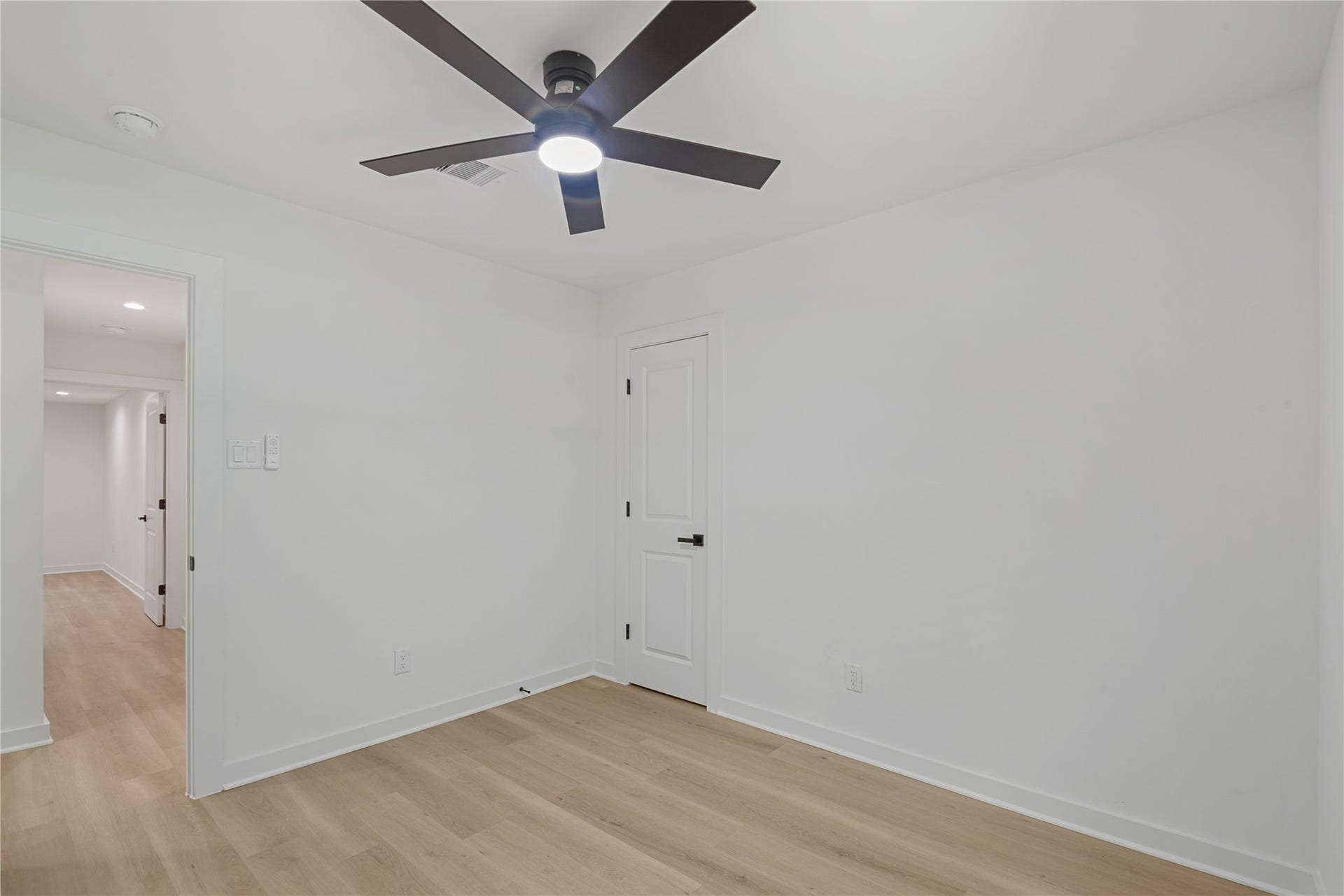 703 Newton Drive, Richmond, TX 77469 Additional bedroom featuring updated flooring, neutral walls, and a contemporary ceiling fan.