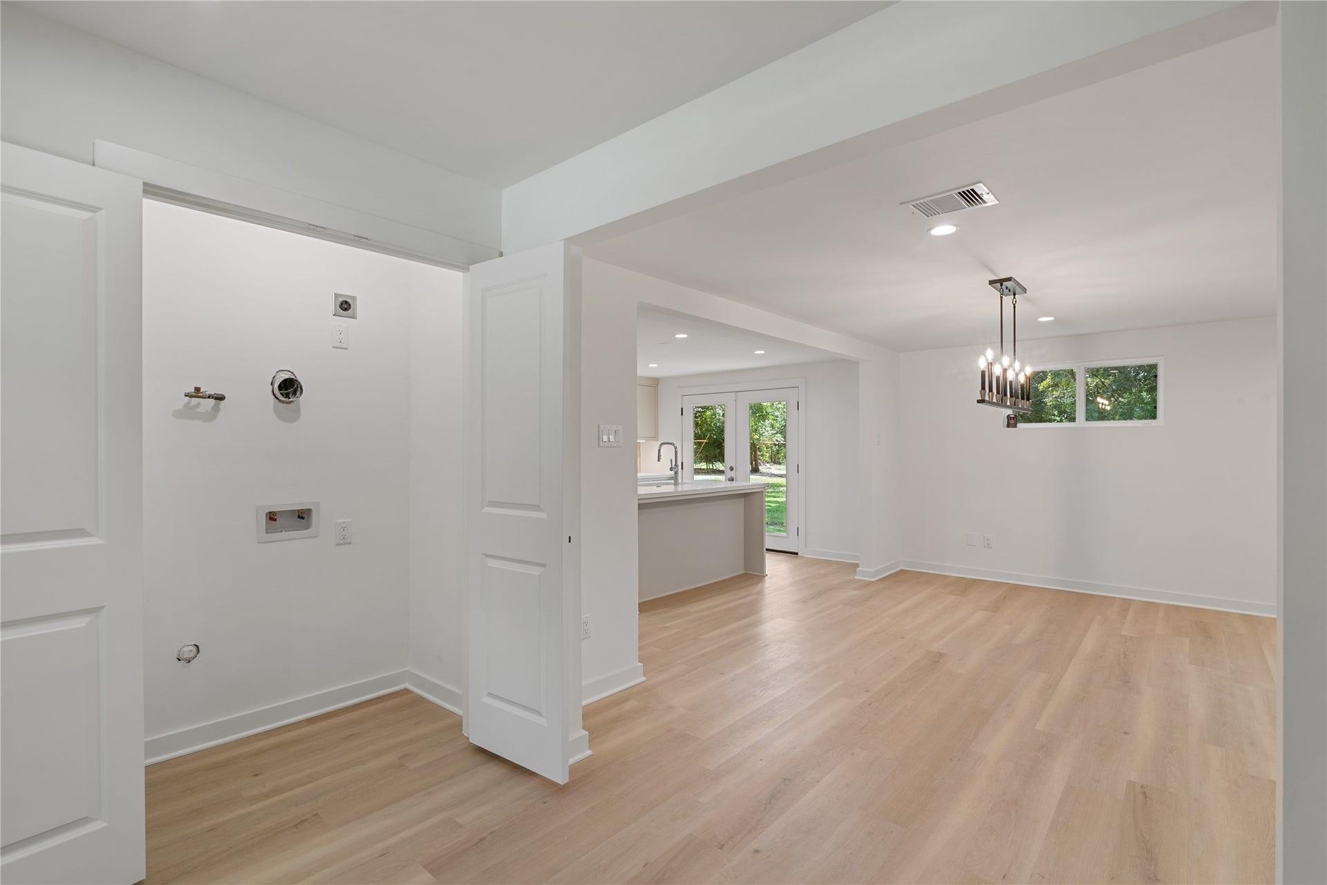 703 Newton Drive, Richmond, TX 77469 Bright interior passage with updated flooring, recessed lighting, and a seamless transition between rooms.
