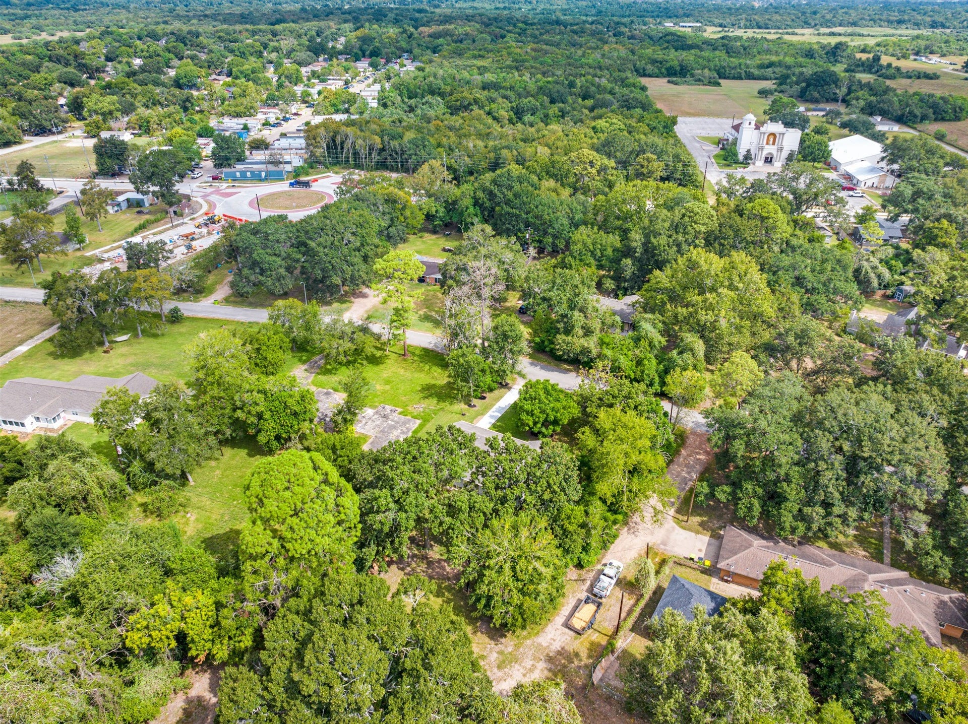 703 Newton Drive, Richmond, TX 77469 Wide aerial view highlighting the surrounding neighborhood, mature tree canopy, and spacious residential setting.