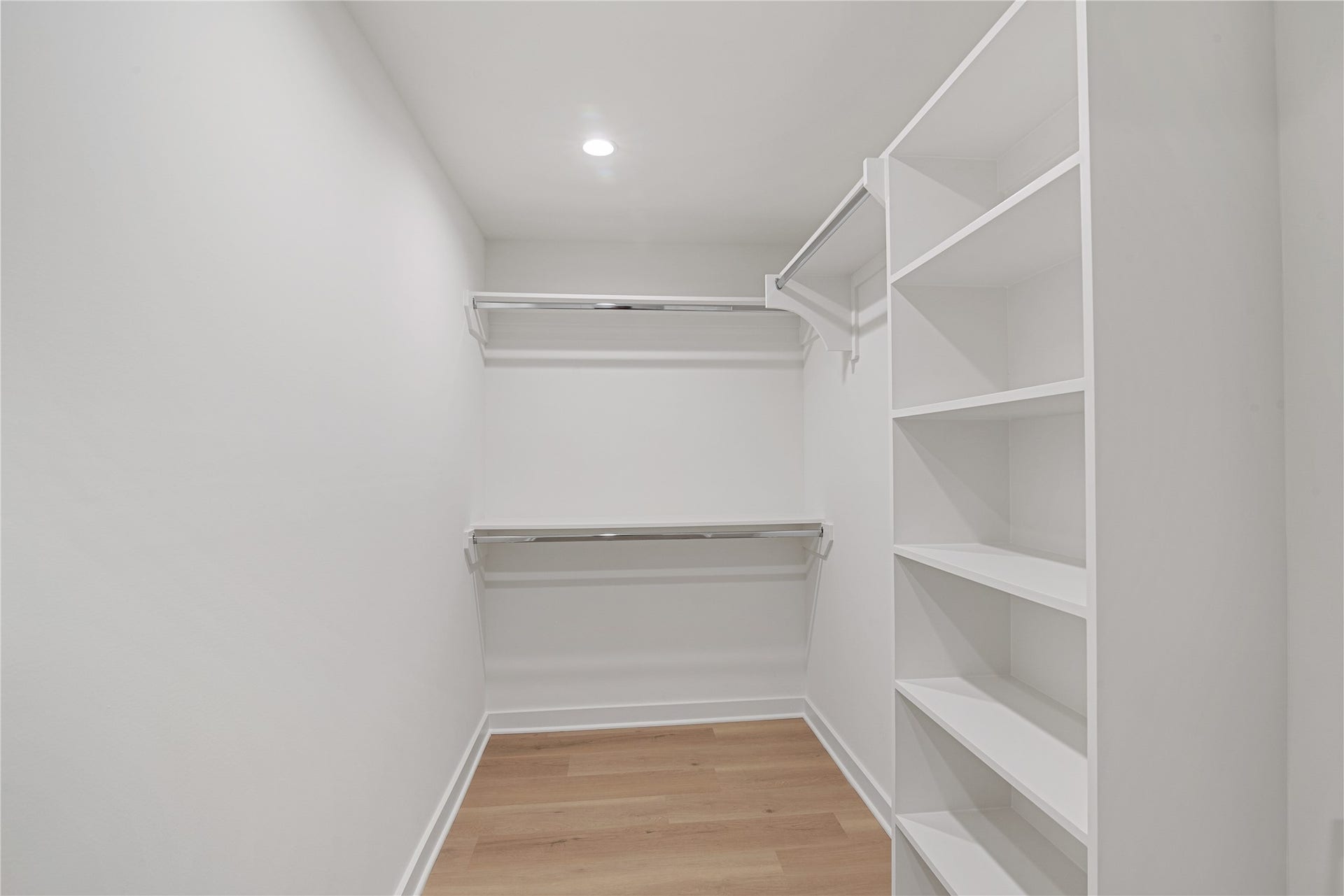 703 Newton Drive, Richmond, TX 77469 Generous walk-in closet with built-in shelving and hanging space for convenient storage and organization.