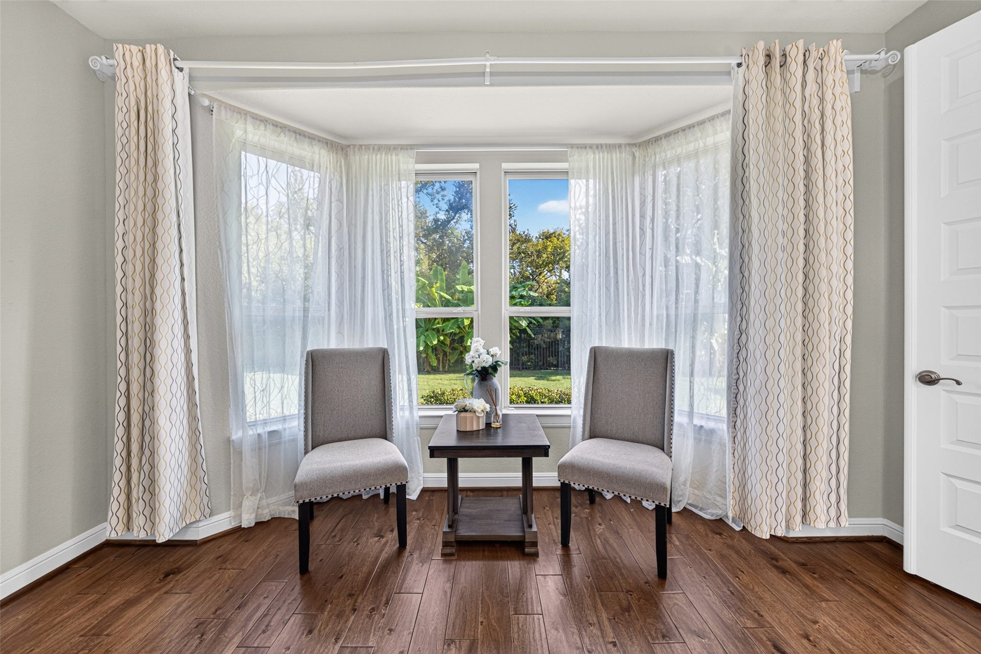 5811 Caper Shores Lane, Sugar Land, TX 77479 Large windows fill this peaceful sitting area with natural light, creating a bright and inviting space to relax