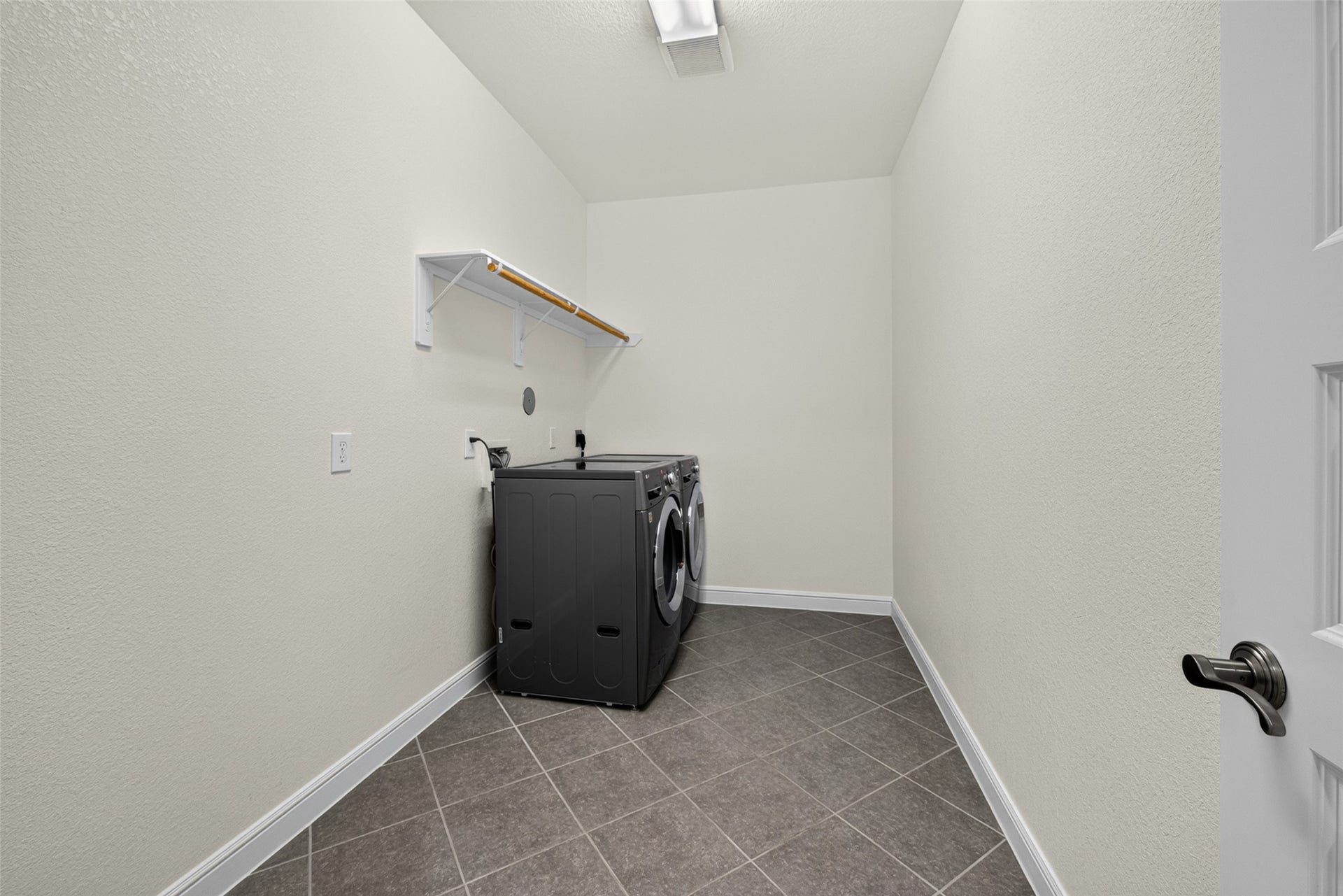 5811 Caper Shores Lane, Sugar Land, TX 77479 Dedicated laundry room offering space for full-sized washer and dryer units.