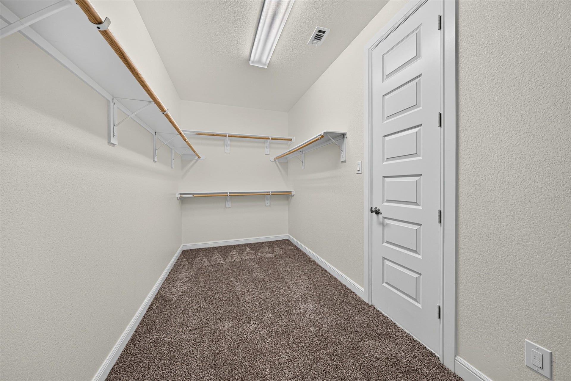 5811 Caper Shores Lane, Sugar Land, TX 77479 Generously sized primary walk-in closet featuring built-in shelving and hanging racks for optimal organization.