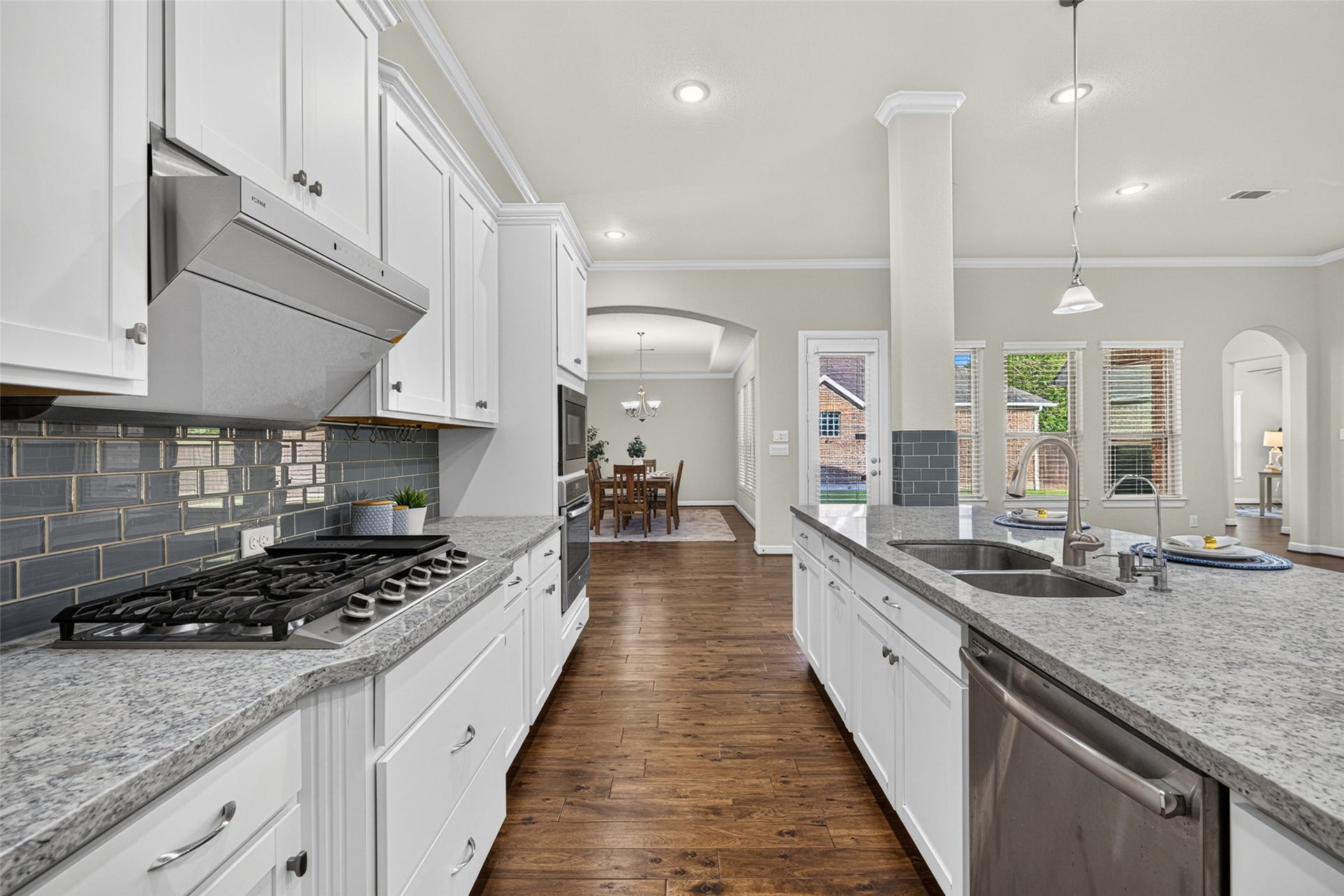 5811 Caper Shores Lane, Sugar Land, TX 77479 At the heart of the home, this warm and welcoming kitchen is made for family meals, morning conversations, and memories shared around the table.