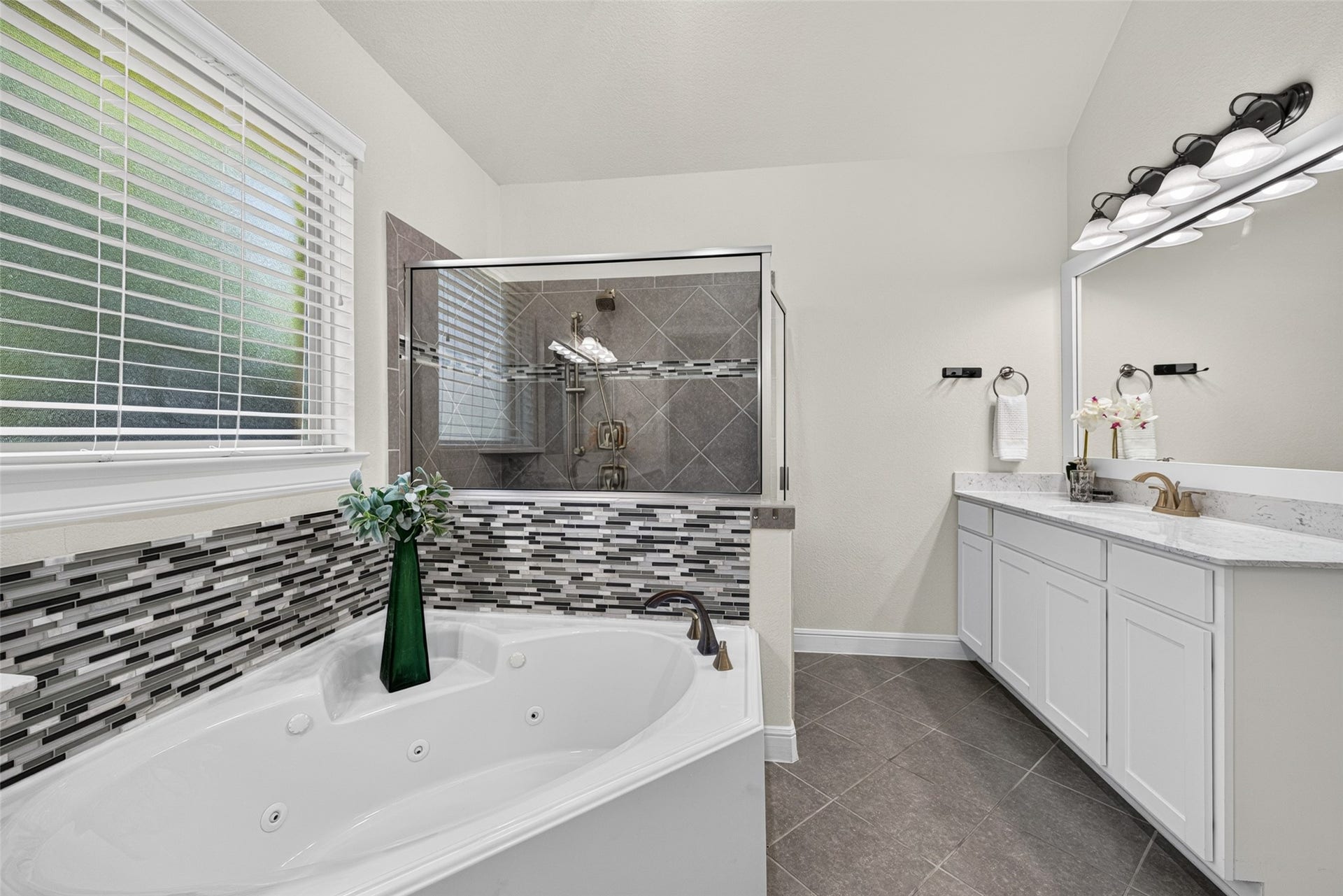 5811 Caper Shores Lane, Sugar Land, TX 77479 Primary bathroom complete with a glass-enclosed walk-in shower, soaking tub, and second vanity.