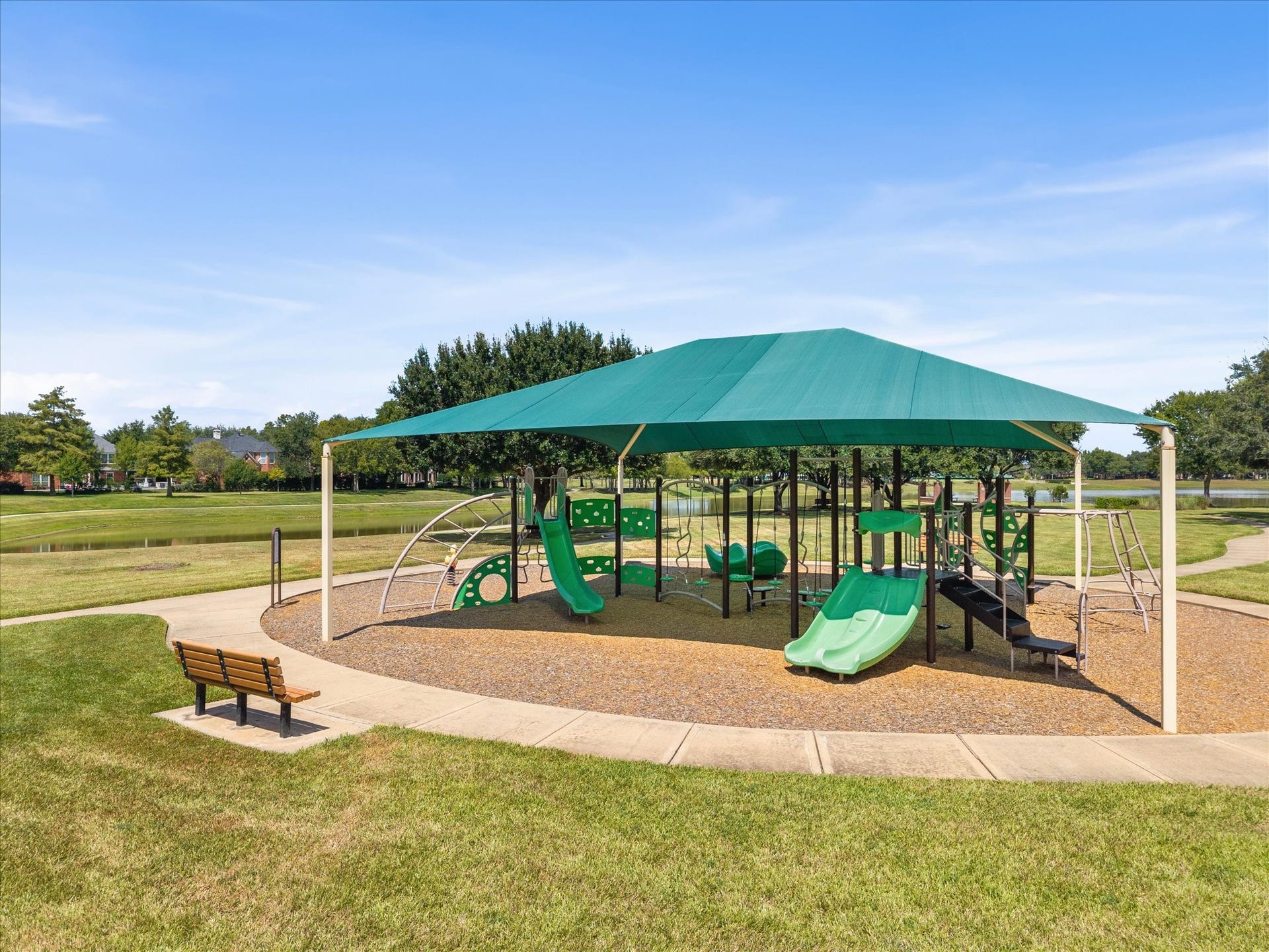 1834 Lake Quitman Drive, Richmond, TX 77406 Second view of the shaded community playground, set right along Figure Four Lake with slides, climbing structures, and plenty of open green space.