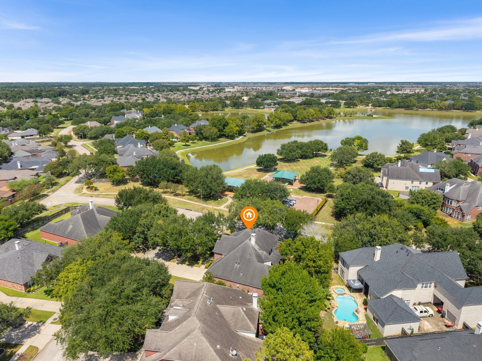 1834 Lake Quitman Drive, Richmond, TX 77406 Aerial view pinpointing the home's location, just a short stroll from Figure Four Lake and the community park, nestled among mature trees in the heart of the neighborhood.