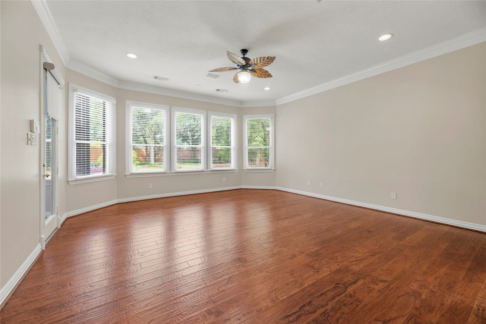 13915 Springmint Drive, Cypress, TX 77429 Primary retreat boasts wood flooring, crown molding, a sitting area, access to the backyard and an en-suite bathroom.