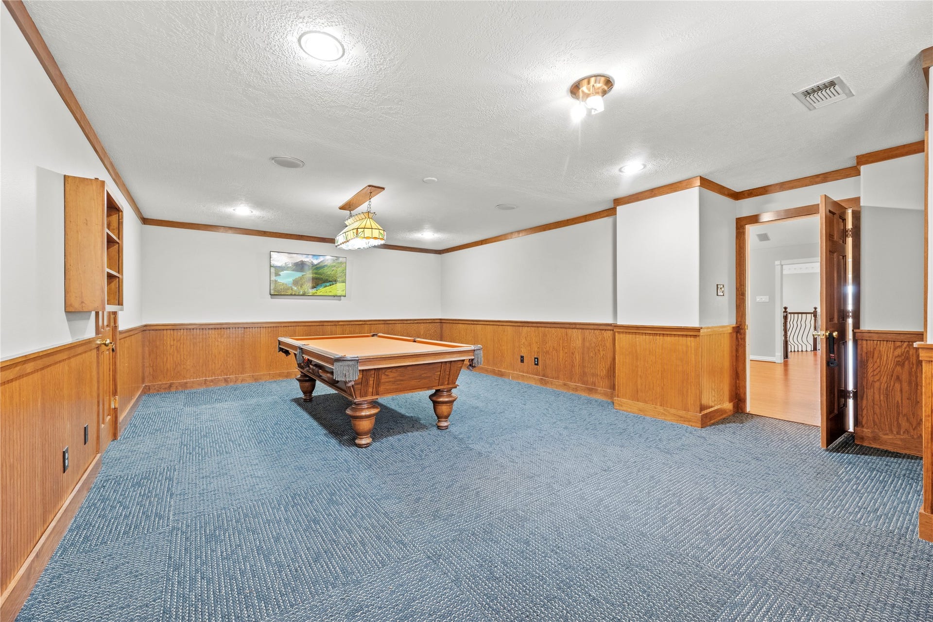 13915 Springmint Drive, Cypress, TX 77429 Upstairs bonus room featuring rich wood wainscoting, carpeted flooring and ample room for billiards, gaming and additional recreational activities.