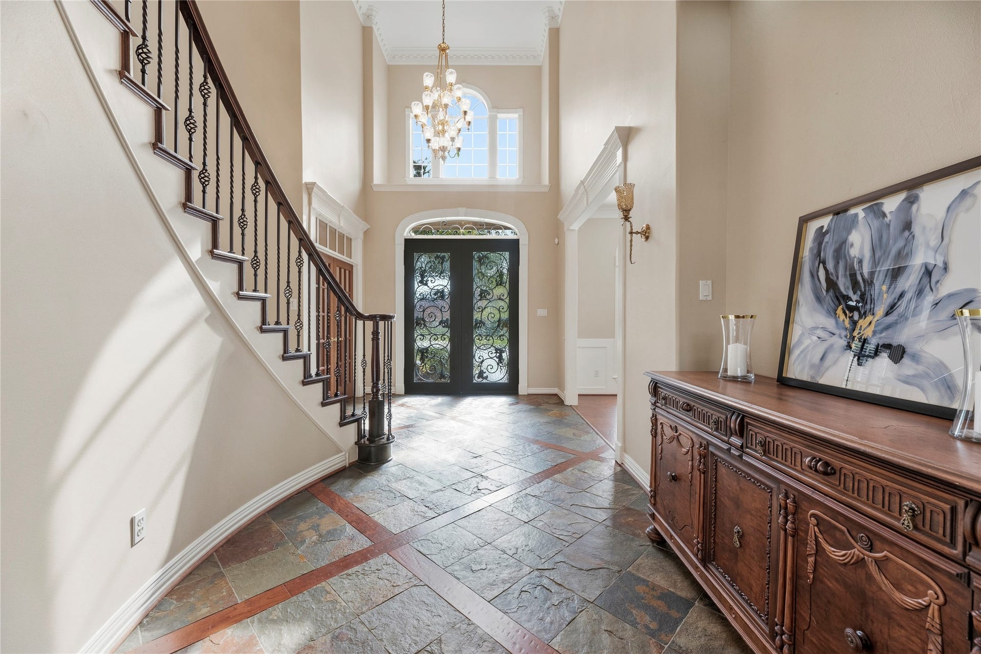 13915 Springmint Drive, Cypress, TX 77429 Beautiful slate flooring, transom windows, soaring ceilings, intricate trim work and an elegant chandelier.