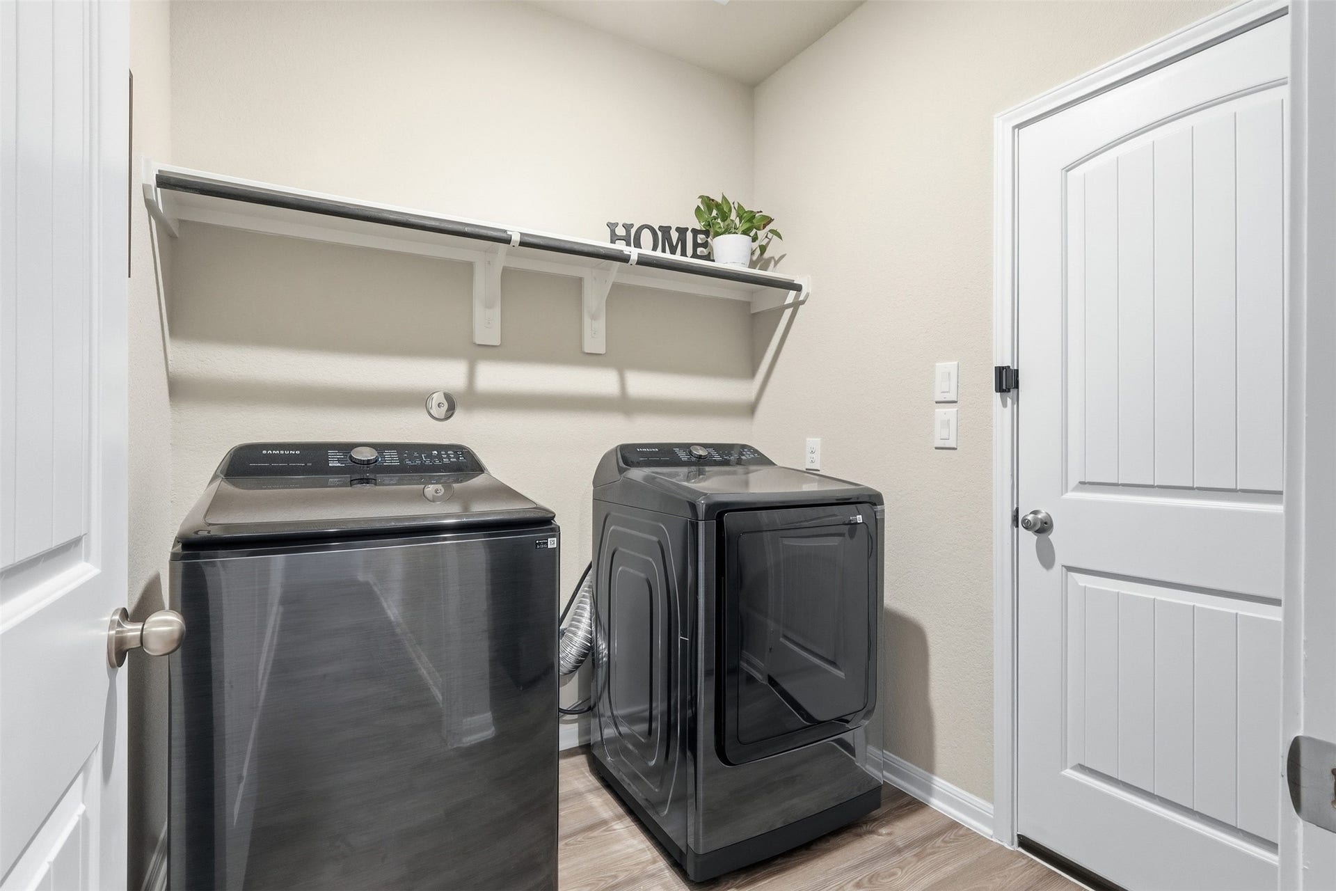 Oversized laundry room offering ample space, abundant storage potential, and a bright, functional layout.