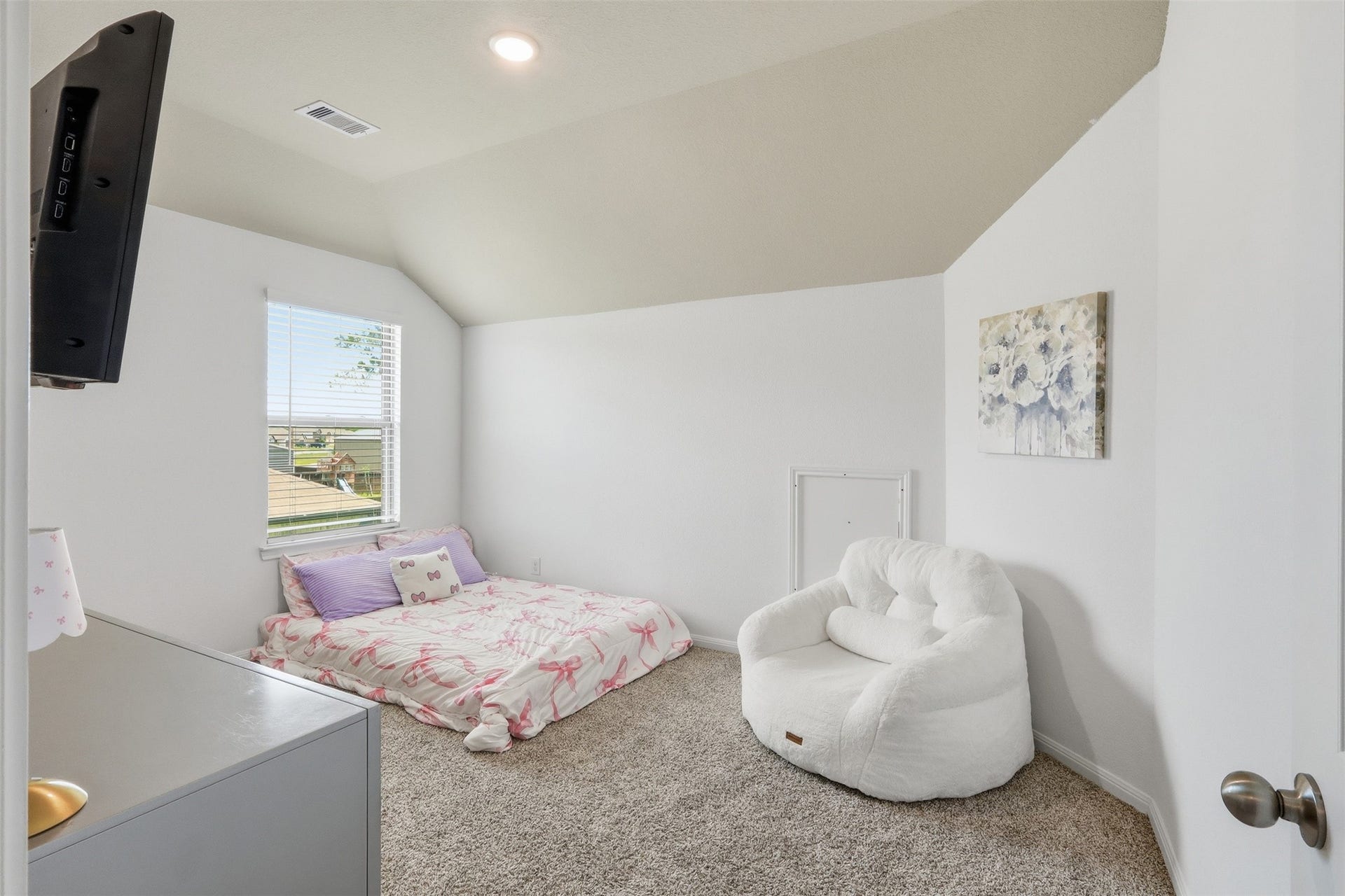 Spacious upstairs secondary bedroom featuring neutral designer colors, abundant natural light, and a versatile layout to fit any lifestyle.