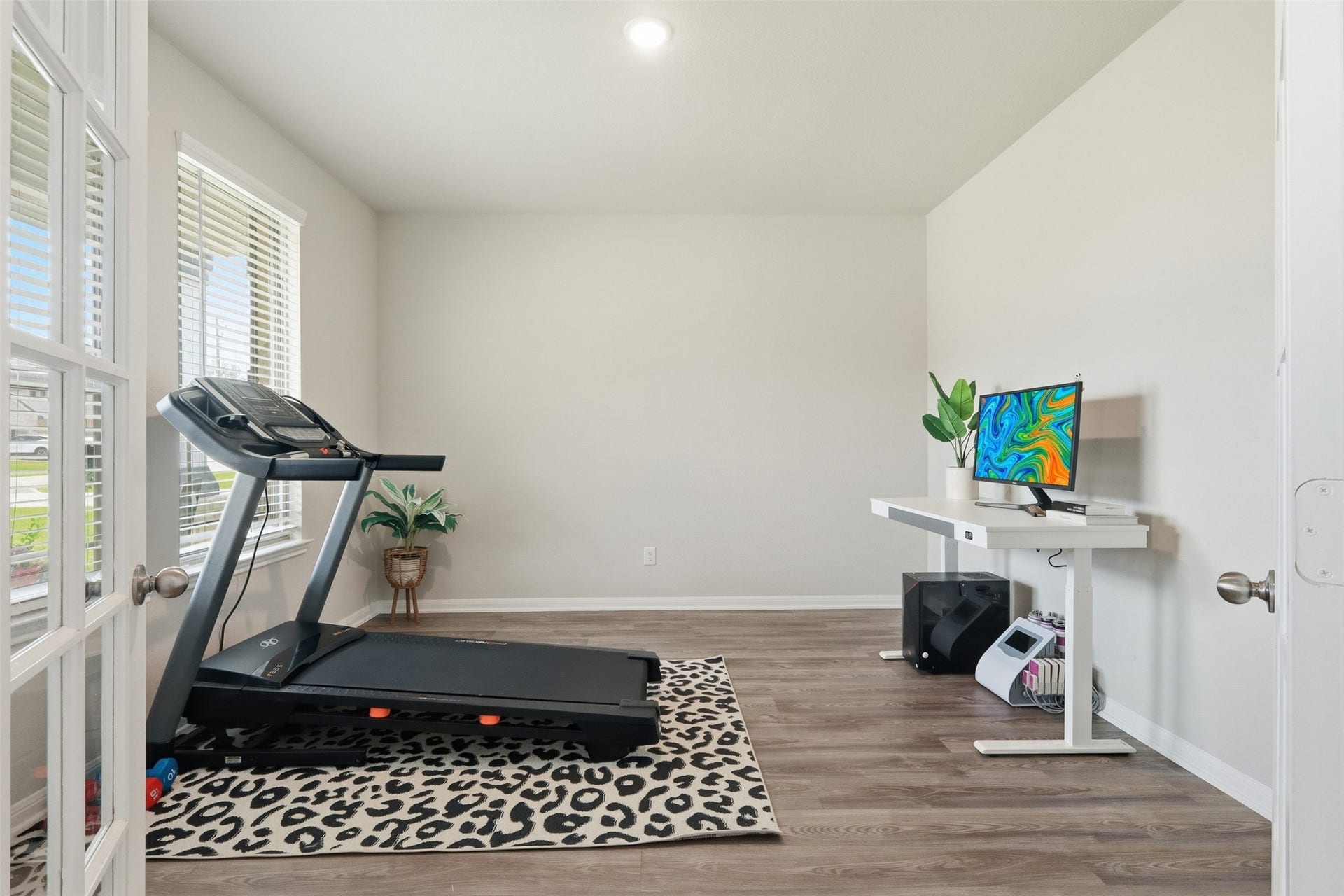 Work from home with ease in this private office featuring abundant natural light, beautiful flooring, and a versatile layout.
