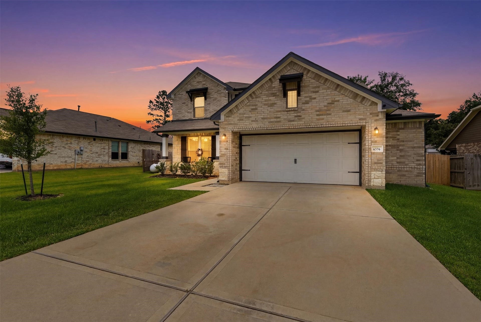 Exceptional curb appeal! Beautiful brick-and-stone exterior featuring an oversized driveway, spacious garage, charming front porch, and a generous .32-acre homesite.