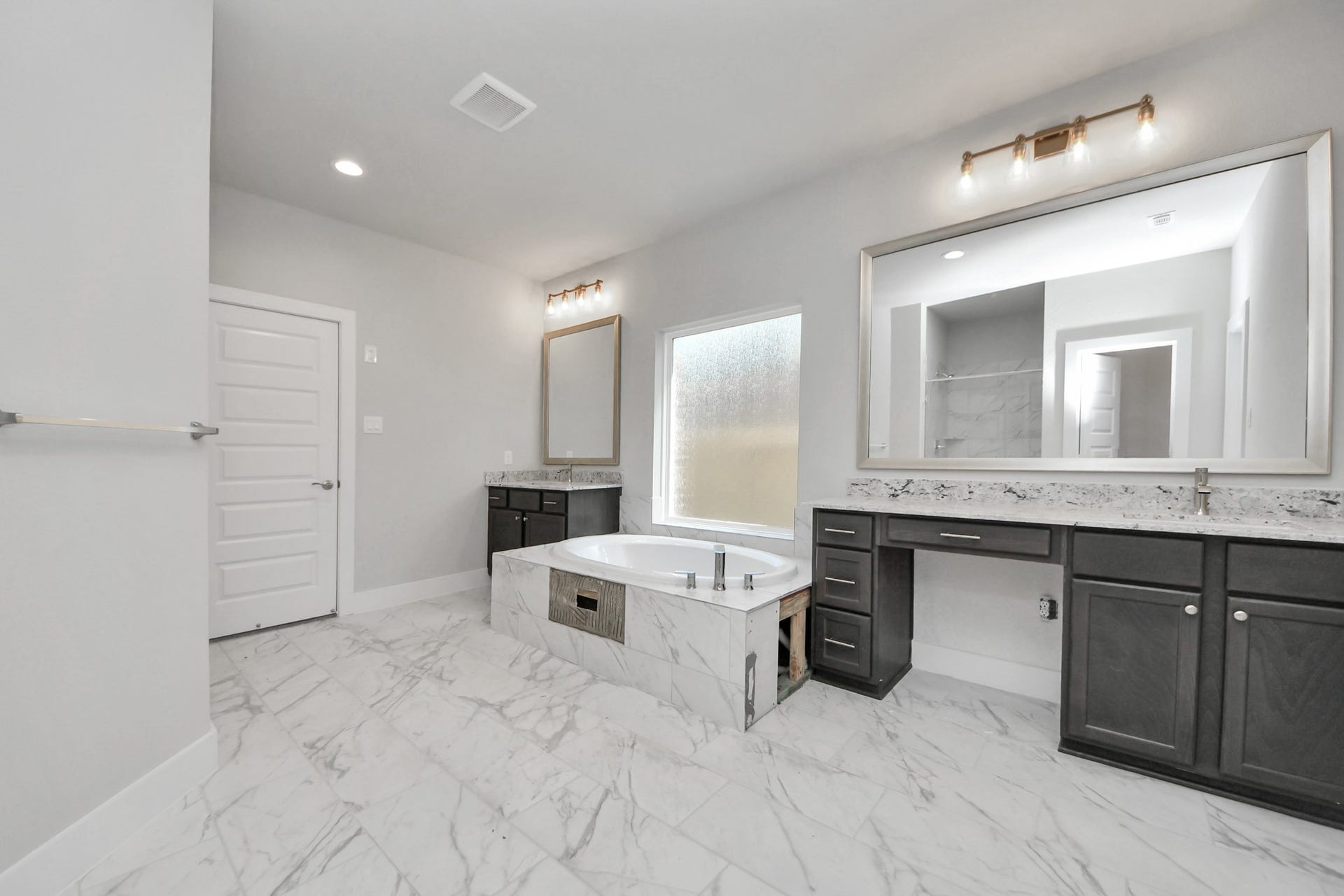 3213 Skerne Spring Drive, Spring, TX 77373 Elevate your daily routine at the elegant vanity, now equipped with double sinks, light countertops, modern hardware, and beautiful vanity lights. Sample photo of completed home with similar floor plan. Actual colors and selections may vary.