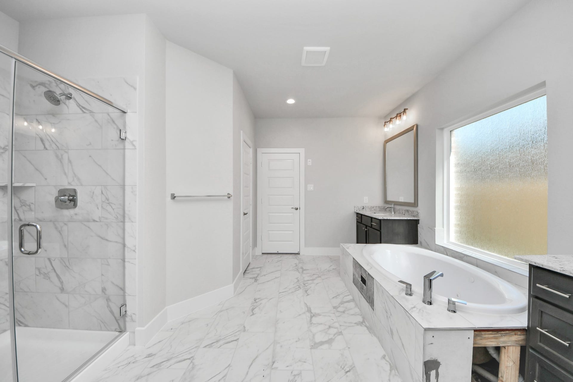 3213 Skerne Spring Drive, Spring, TX 77373 Indulge in a spa-like retreat within the confines of this primary bathroom. Delight in a spacious walk-in shower enveloped in stylish tile surround, unwind in a separate garden tub adorned with custom detailing. Sample photo of completed home with similar floor plan. Actual colors and selections may vary.