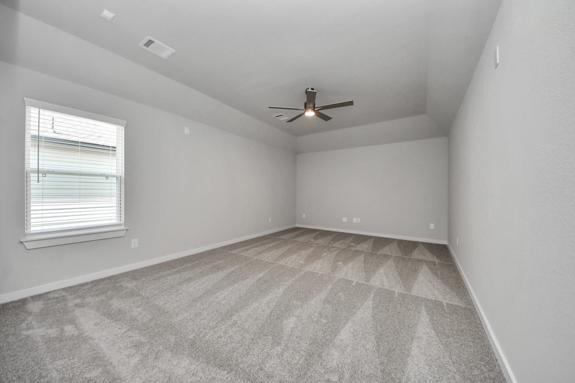 3213 Skerne Spring Drive, Spring, TX 77373 Secondary bedroom features plush carpeting, large windows that let in plenty of natural light, bright paint, and spacious closets. Sample photo of completed home with similar floor plan. Actual colors and selections may vary.