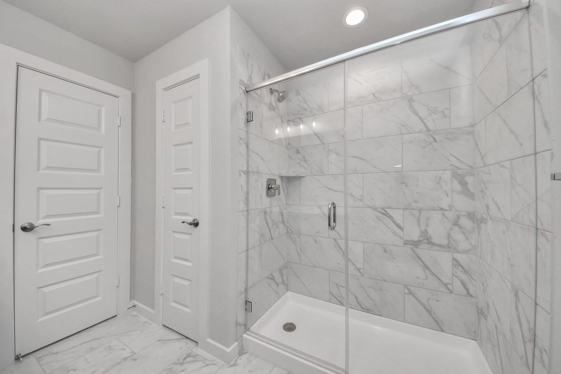 3213 Skerne Spring Drive, Spring, TX 77373 Secondary bath features tile flooring, walk-in shower with tile surround, light stained wood cabinets, beautiful light countertop. Sample photo of completed home with similar floor plan. Actual colors and selections may vary.