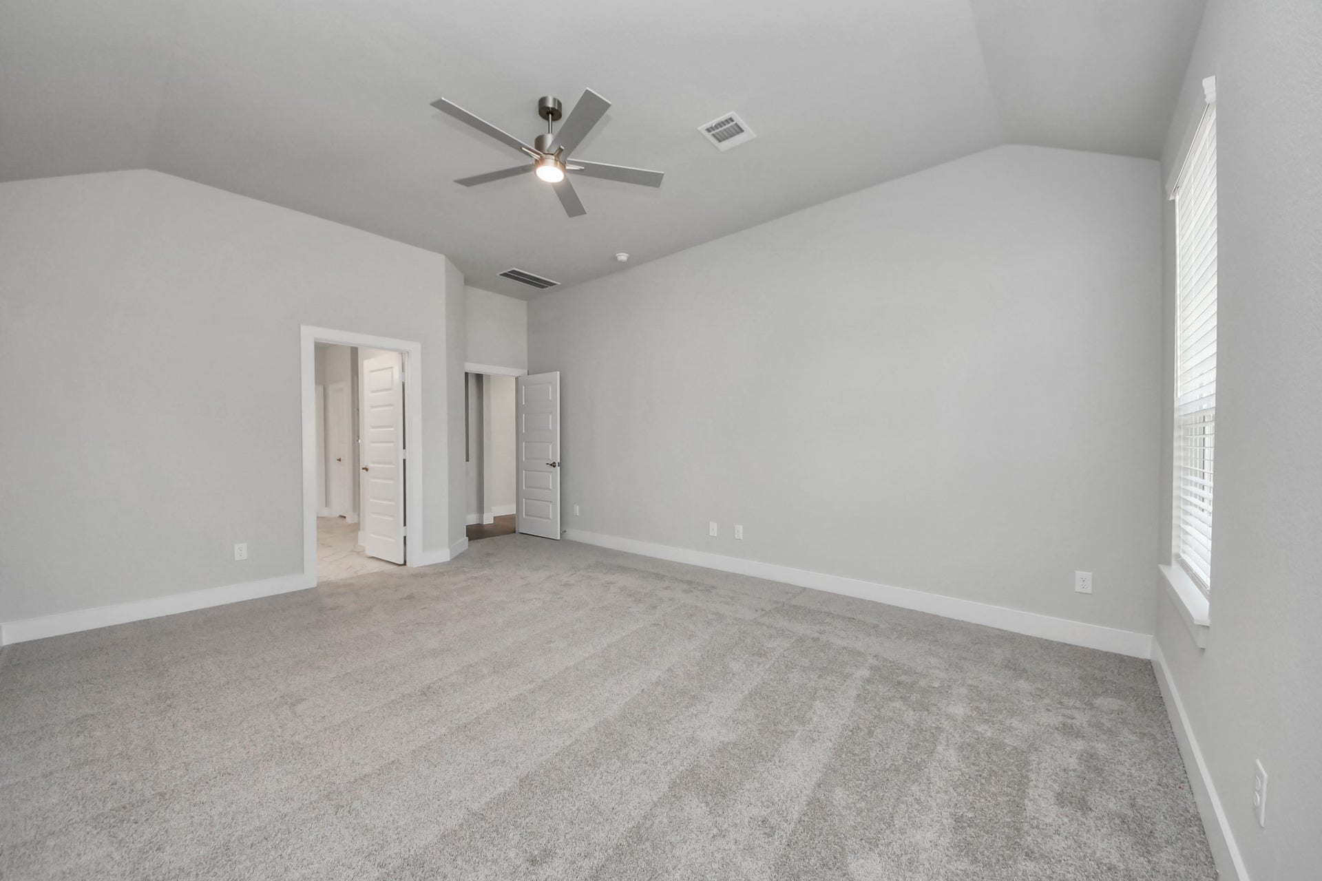 3213 Skerne Spring Drive, Spring, TX 77373 Come and unwind after a long day in this magnificent primary suite! This spacious room features plush carpet, warm paint, high ceilings and large windows with privacy blinds. Sample photo of completed home with similar floor plan. Actual colors and selections may vary.