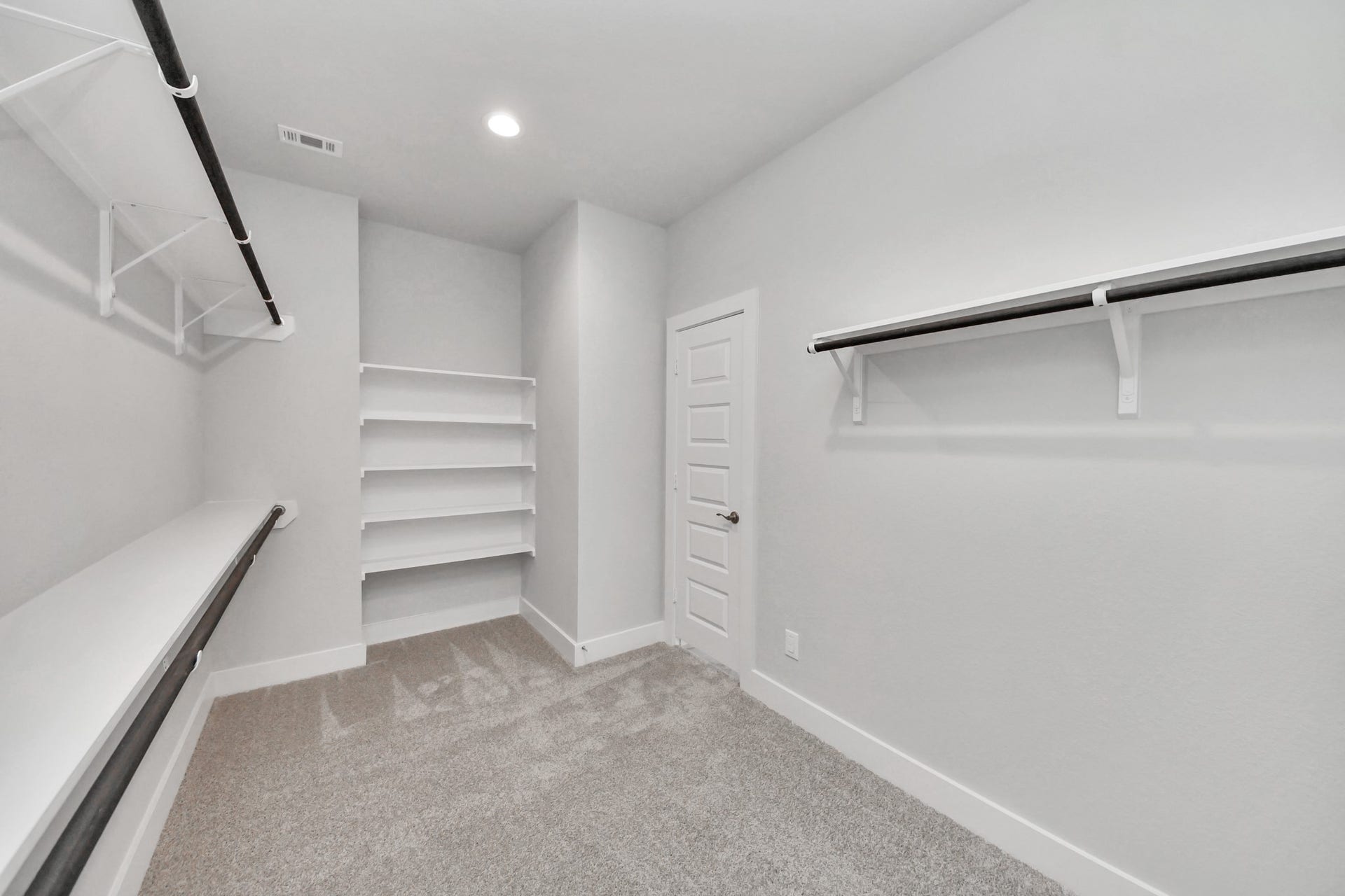 3213 Skerne Spring Drive, Spring, TX 77373 Walk-in closet that epitomizes luxury and practicality. This generously sized space features built-in shelving, offering abundant room for impeccable organization. High ceilings and recessed lighting create a bright and welcoming ambiance. Sample photo of completed home with similar floor plan. Actual colors and selections may vary.