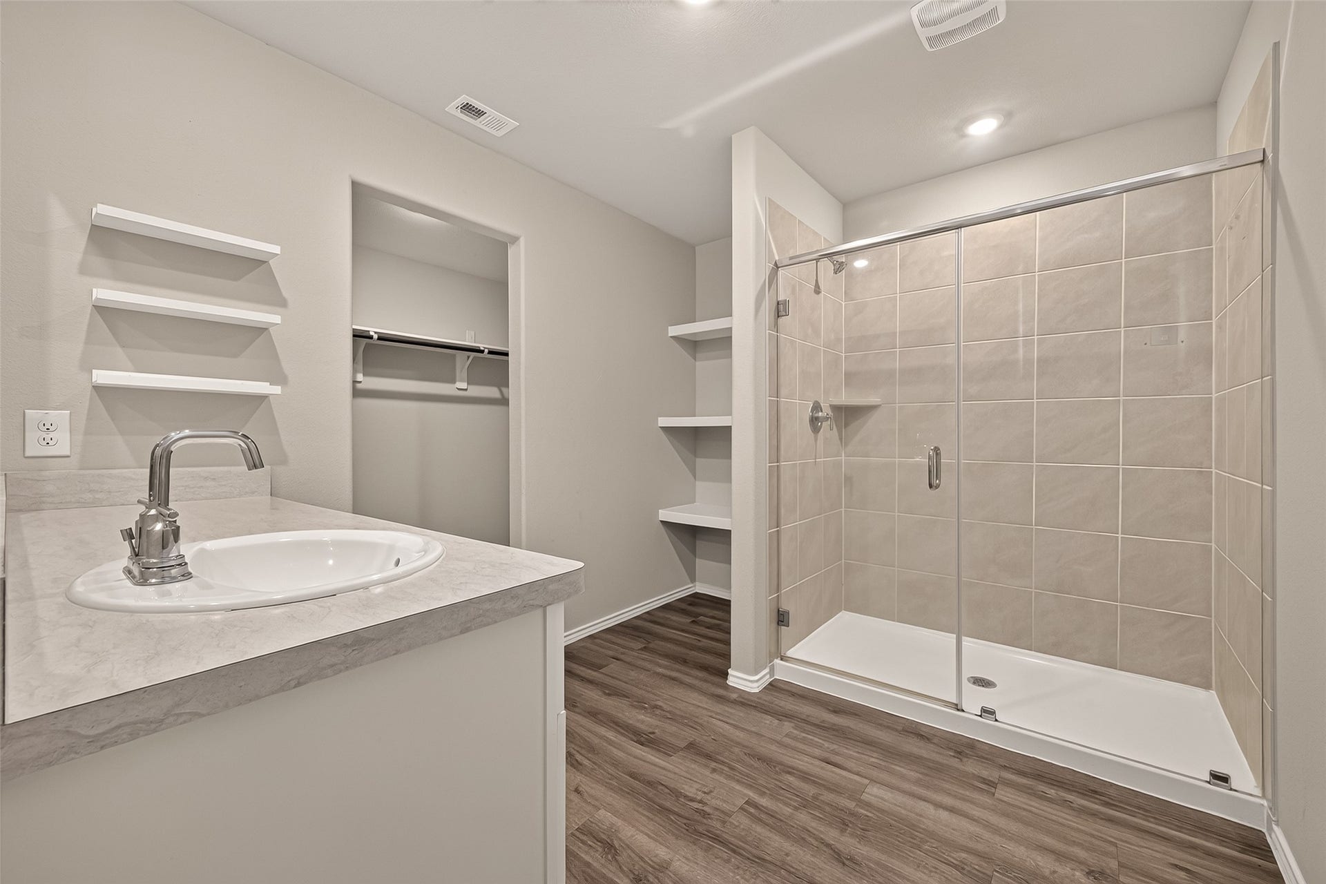 25471 Blue Mistflower Drive, Montgomery, TX 77316 Primary Bathroom with large walk in shower, linen storage, display shelves on wall and walk-in closet entry