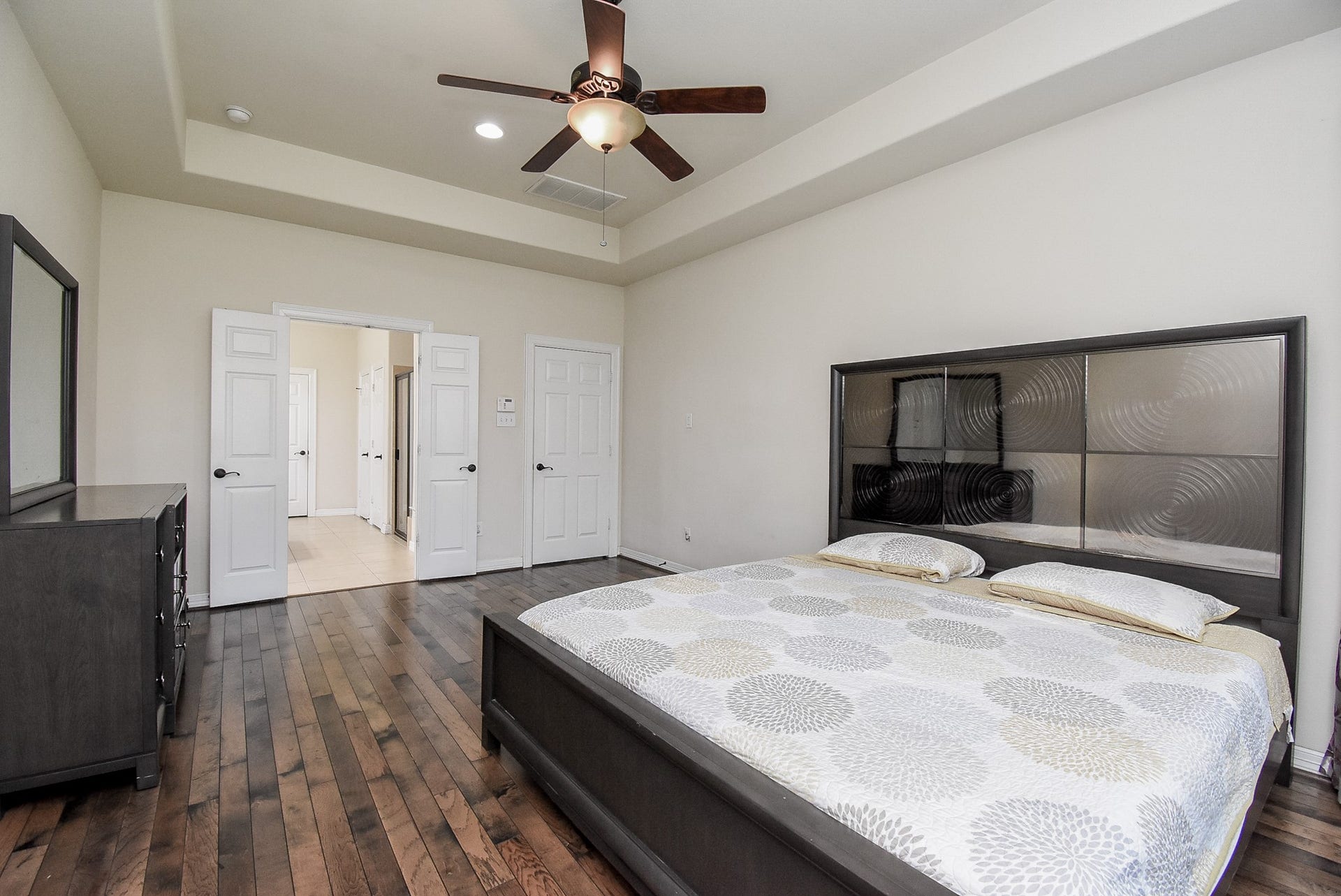 27807 Ashbrook Falls Court, Fulshear, TX 77441 Alternate view of the primary bedroom, with the tray ceiling and french doors it gives you added elegance throughout the room.
