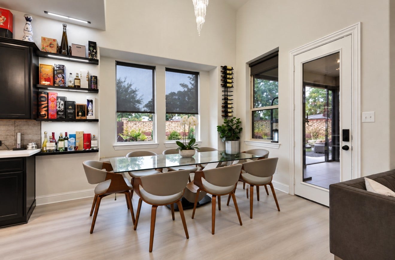 2120 Rosenthal Lane, Houston, TX 77080 Light-filled dining area featuring high ceilings, updated flooring, and large windows overlooking the backyard. Conveniently located beside the kitchen with direct access to the screened-in covered patio.