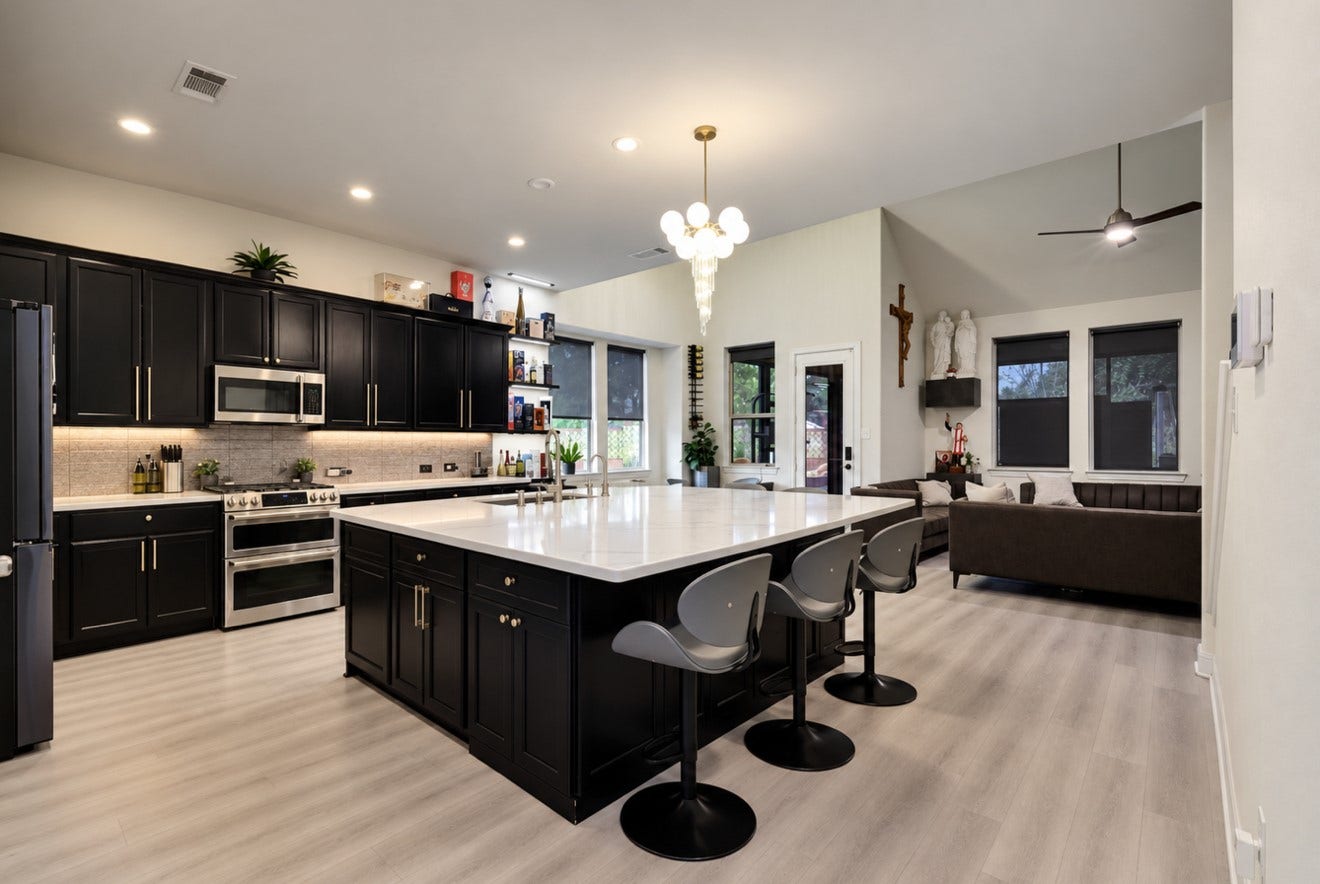 2120 Rosenthal Lane, Houston, TX 77080 Beautifully updated kitchen featuring a remodeled oversized island with breakfast bar seating, new countertops, and new appliances. Rich dark cabinetry with hardware, under-cabinet lighting, and a statement light fixture creates a stylish space that opens to the main living areaideal for everyday living and entertaining.