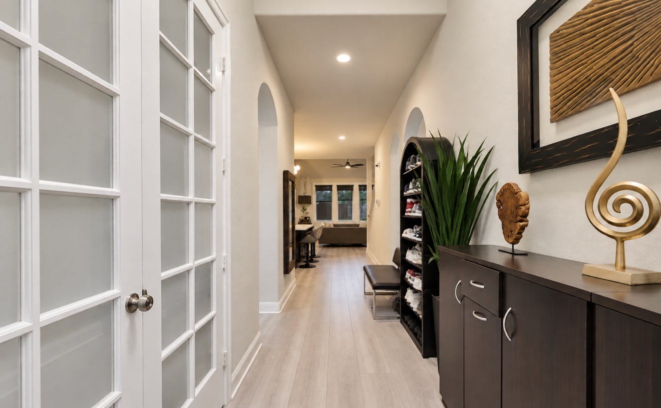 2120 Rosenthal Lane, Houston, TX 77080 An inviting foyer with high ceilings, elegant arched openings, recessed lighting, and updated flooring creates a welcoming entrance that flows into the main living area.