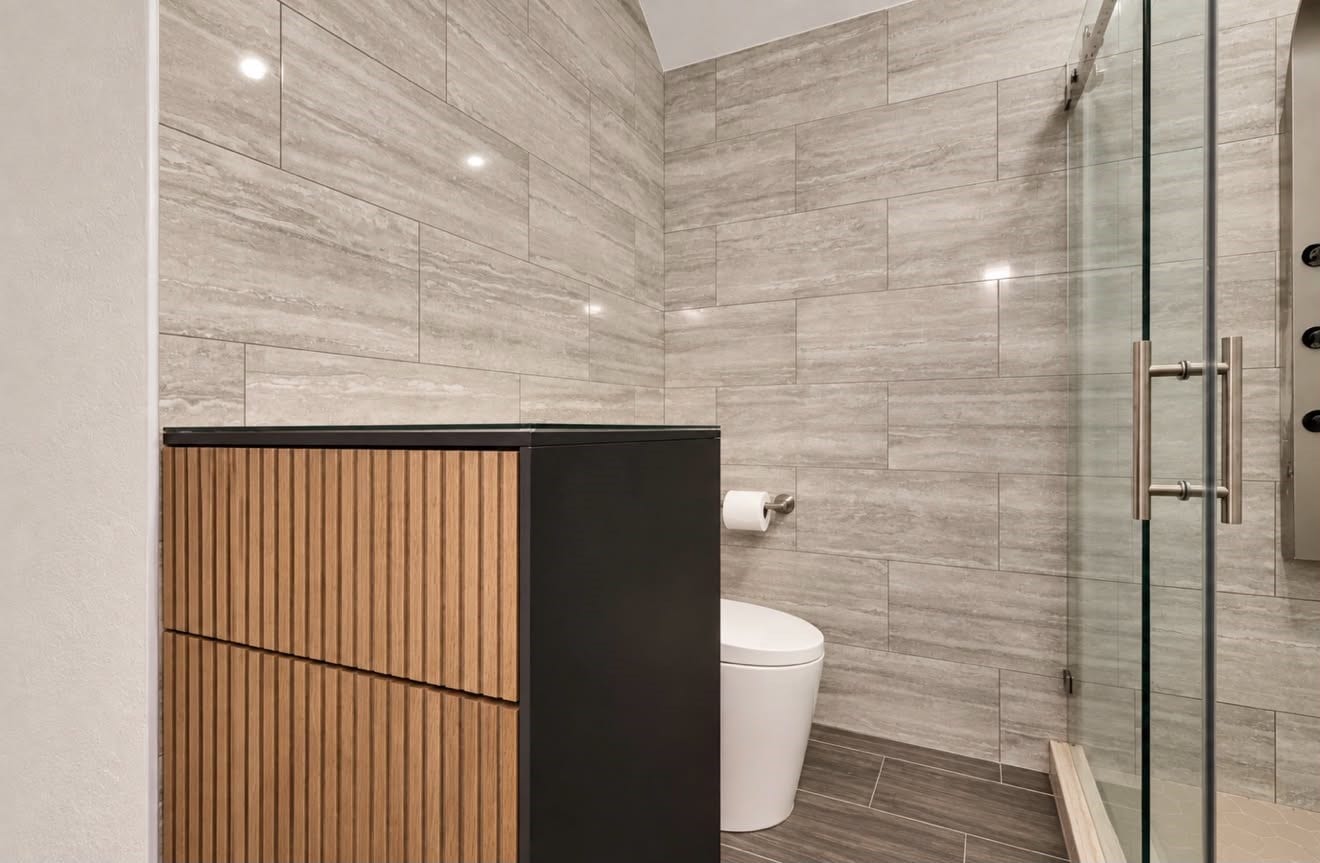 2120 Rosenthal Lane, Houston, TX 77080 Fully renovated upstairs Jack-and-Jill bathroom featuring updated finishes, a walk-in shower, and convenient access from both adjoining bedrooms, combining style with everyday functionality.