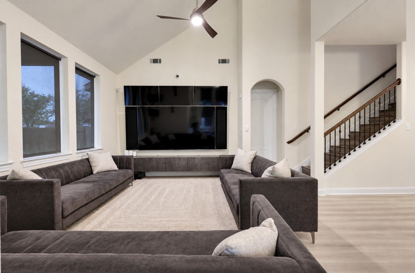 2120 Rosenthal Lane, Houston, TX 77080 Inviting living area featuring high ceilings, updated flooring, and abundant natural light. The open layout connects to the kitchen and dining area for easy everyday living and entertaining, with convenient access to the staircase leading upstairs.
