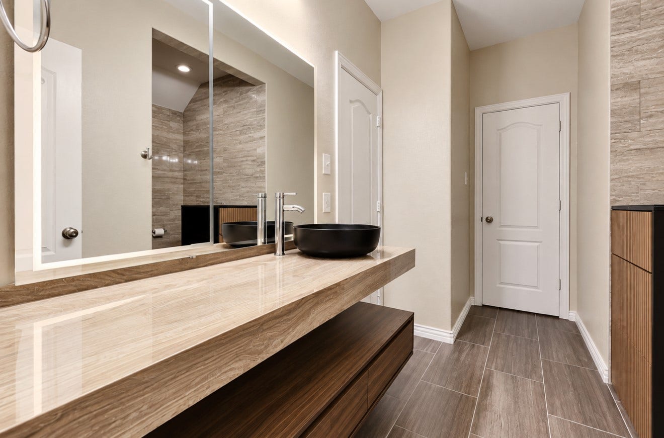 2120 Rosenthal Lane, Houston, TX 77080 Fully renovated upstairs Jack-and-Jill bathroom featuring updated finishes, a walk-in shower, and convenient access from both adjoining bedrooms, combining style with everyday functionality.