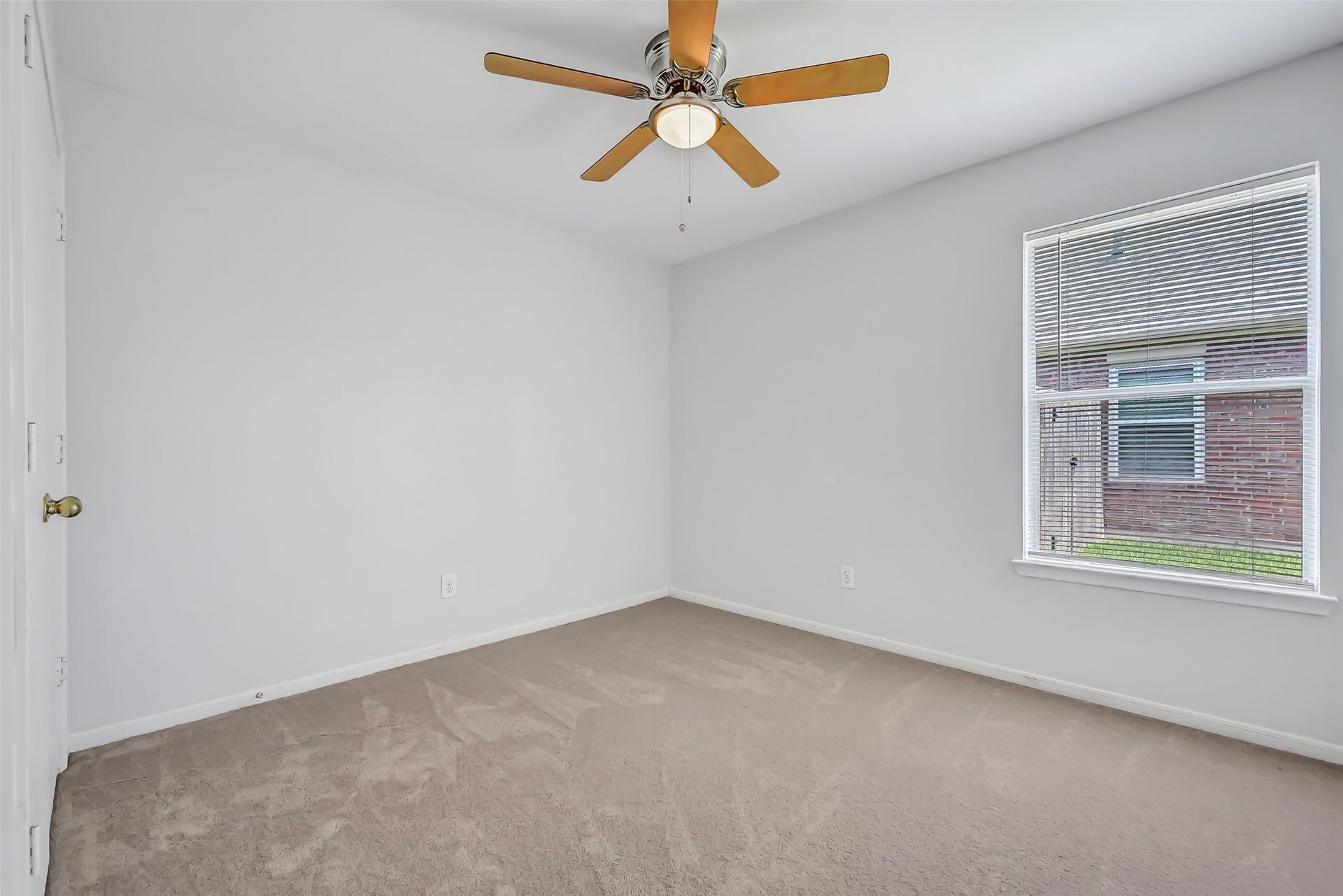 3115 Berryfield Lane, Pearland, TX 77581 Located on the opposite side of the home from the primary suite, this secondary bedroom continues the fresh, neutral interior with brand-new plush carpet & fresh paint. A lighted ceiling fan, large window and closet make it a comfortable, versatile space for family or guests.