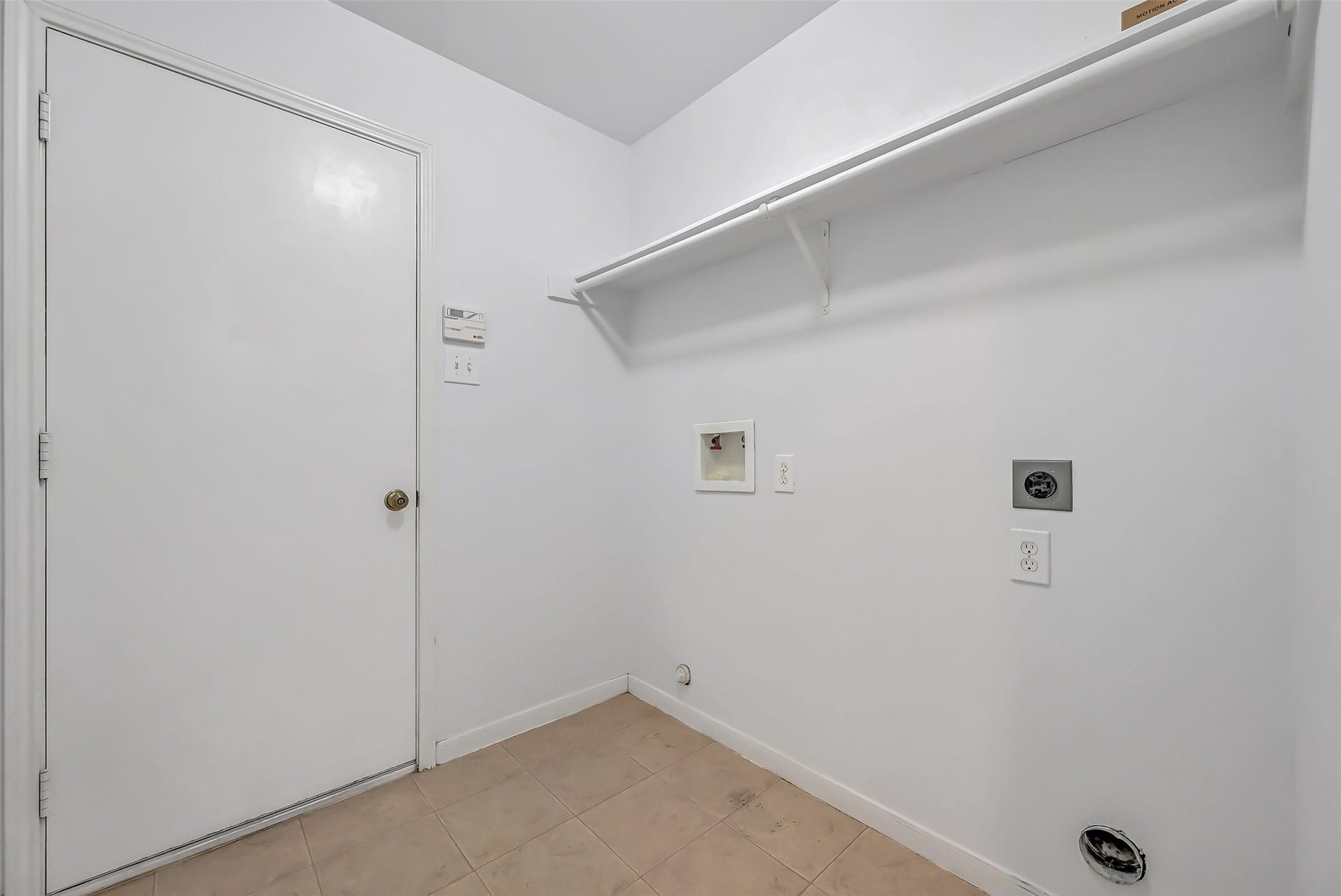 3115 Berryfield Lane, Pearland, TX 77581 The dedicated utility room offers washer & dryer connections, tile flooring and overhead shelving for laundry essentials. The door at left leads directly into the finished 2-car garage, complete with epoxy flooringa nice bonus that adds a clean, polished finish to this hardworking space.
