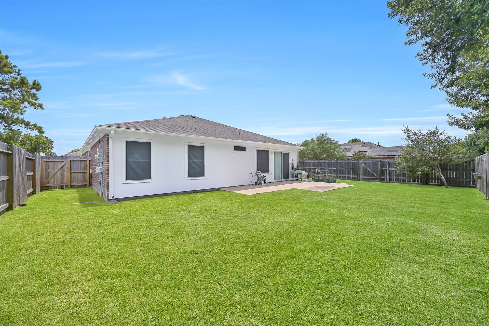 3115 Berryfield Lane, Pearland, TX 77581 Now THAT'S a backyard! The corner lot provides an impressively spacious fenced yard with plenty of green space to play, garden or simply enjoy the outdoors. A large concrete patio just outside the kitchen offers an easy spot for grilling, outdoor dining or relaxing in the shade.