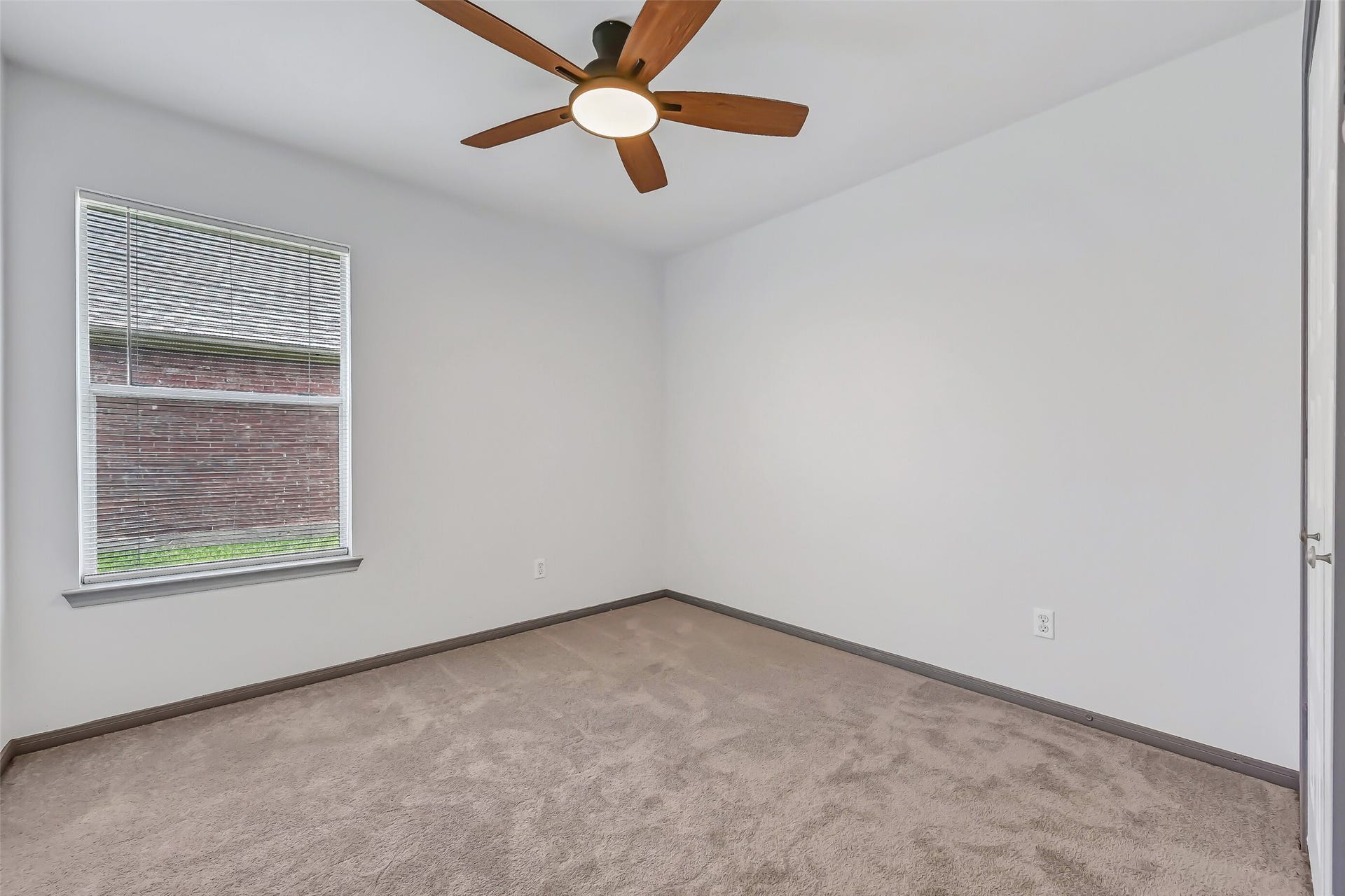 3115 Berryfield Lane, Pearland, TX 77581 The second secondary bedroom offers another freshly updated space with brand-new plush carpet, fresh paint, a large window and modern lighted ceiling fan. The split-bedroom layout keeps both secondary rooms together while providing nice separation from the private primary suite.
