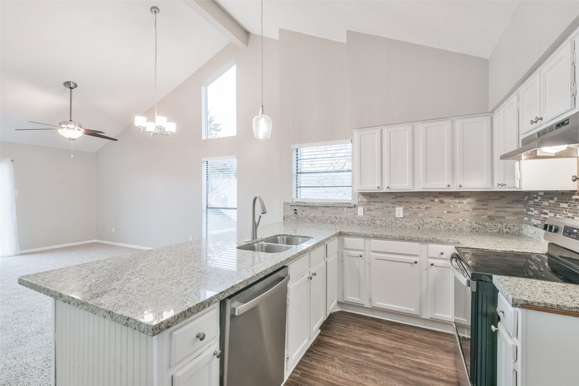 The open concept recently renovated kitchen opens to the main living and dining areas.