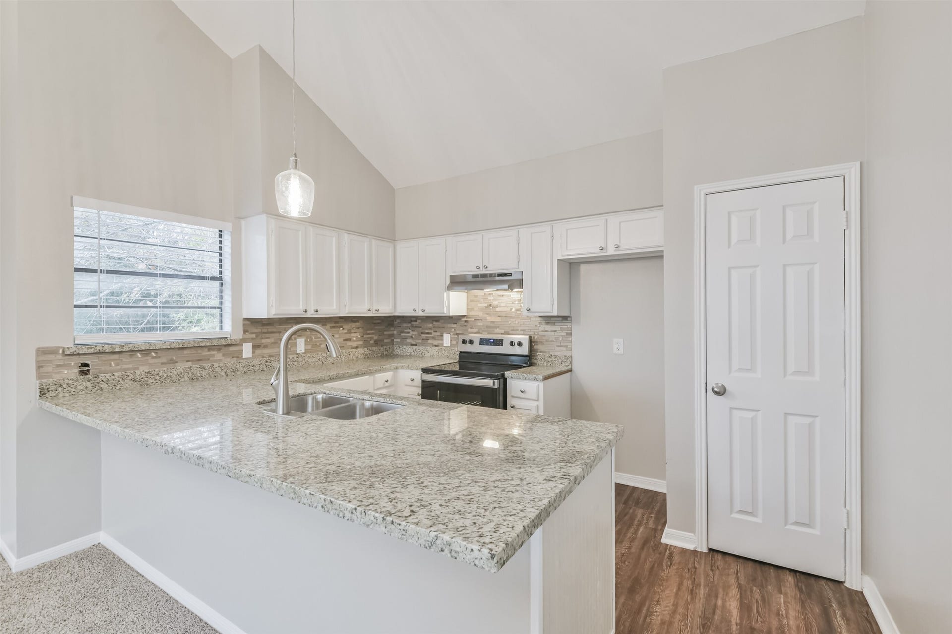 The kitchen peninsula provides additional seating for dining.