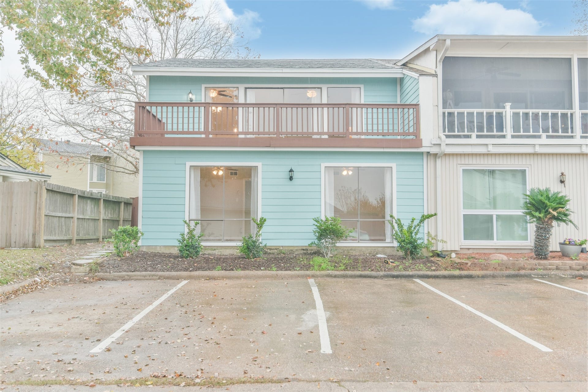 The balcony on the main living area overlooks the neighborhood and offers a glimpse of Lake Conroe.