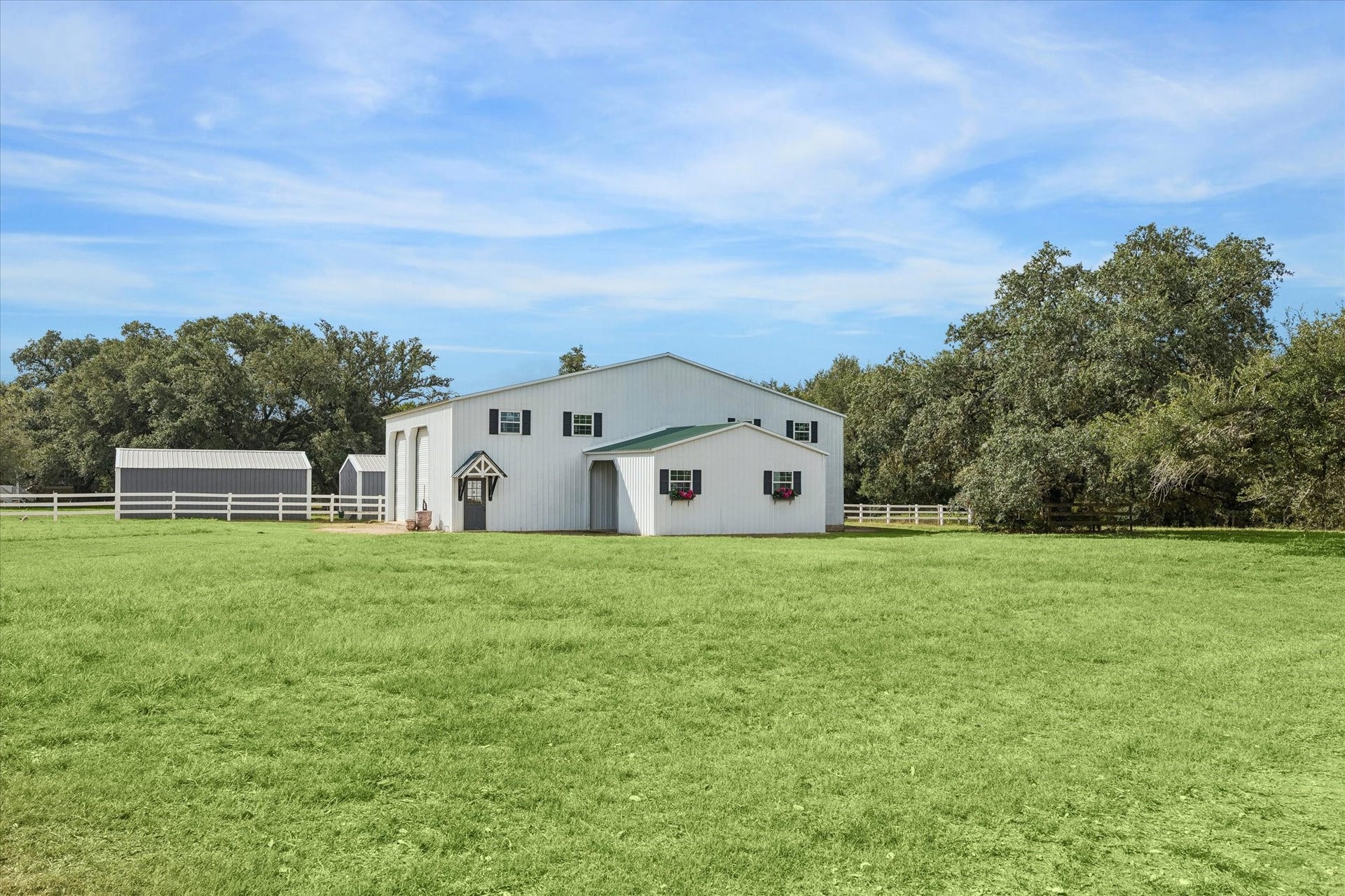 4050 Fm 2714, Round Top, TX 78954 Spacious equipment barn with ample hay storage, offering exceptional functionality and abundant room for ranch equipment and essentials.